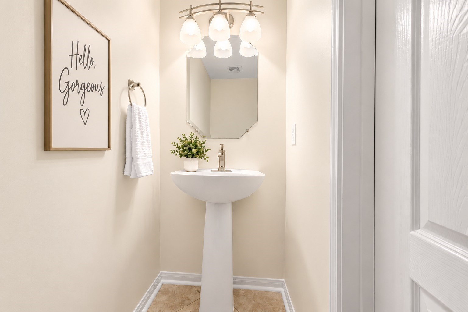 ust steps from the family room, this charming GUEST HALF BATH is perfectly positioned for family & visitors alike! Features include a stylish pedestal sink, brushed-nickel fixtures, contemporary three-light vanity lighting with frosted glass shades, decorative mirror & easy-care tile flooring. NO NEED FOR GUESTS TO VENTURE INTO YOUR PRIVATE LIVING QUARTERS!