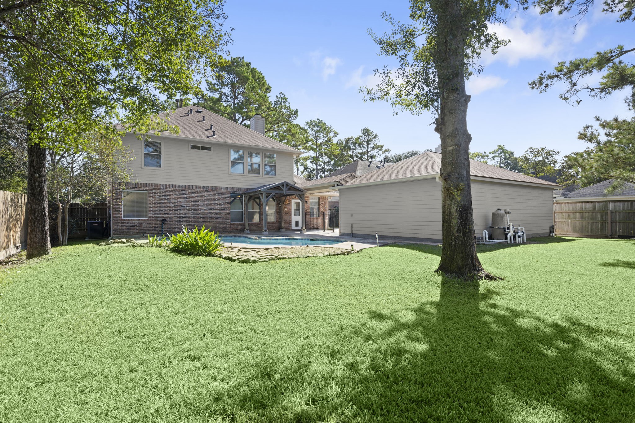 YOUR PRIVATE BACKYARD OASIS! Sparkling freeform pool, mature shade trees, lush landscaping, and plenty of green space for Fido, a playset, or family gatherings! Attractive brick and Hardie siding exterior, newer roof, and LeafGuard gutters offer added peace of mind. Outdoor living at its finest!