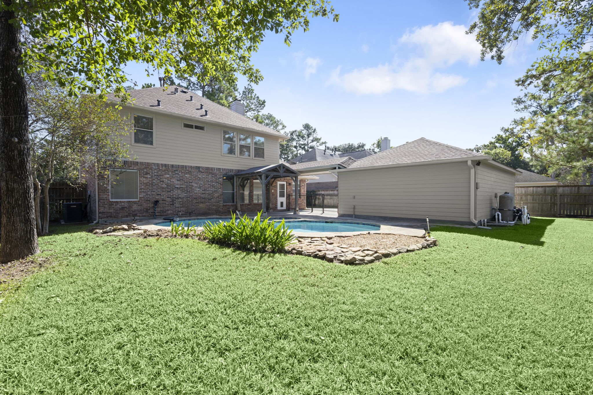 YOUR PRIVATE BACKYARD OASIS! Sparkling freeform pool, mature shade trees, lush landscaping, and plenty of green space for Fido, a playset, or family gatherings! Attractive brick and Hardie siding exterior, newer roof, and LeafGuard gutters offer added peace of mind. Outdoor living at its finest!