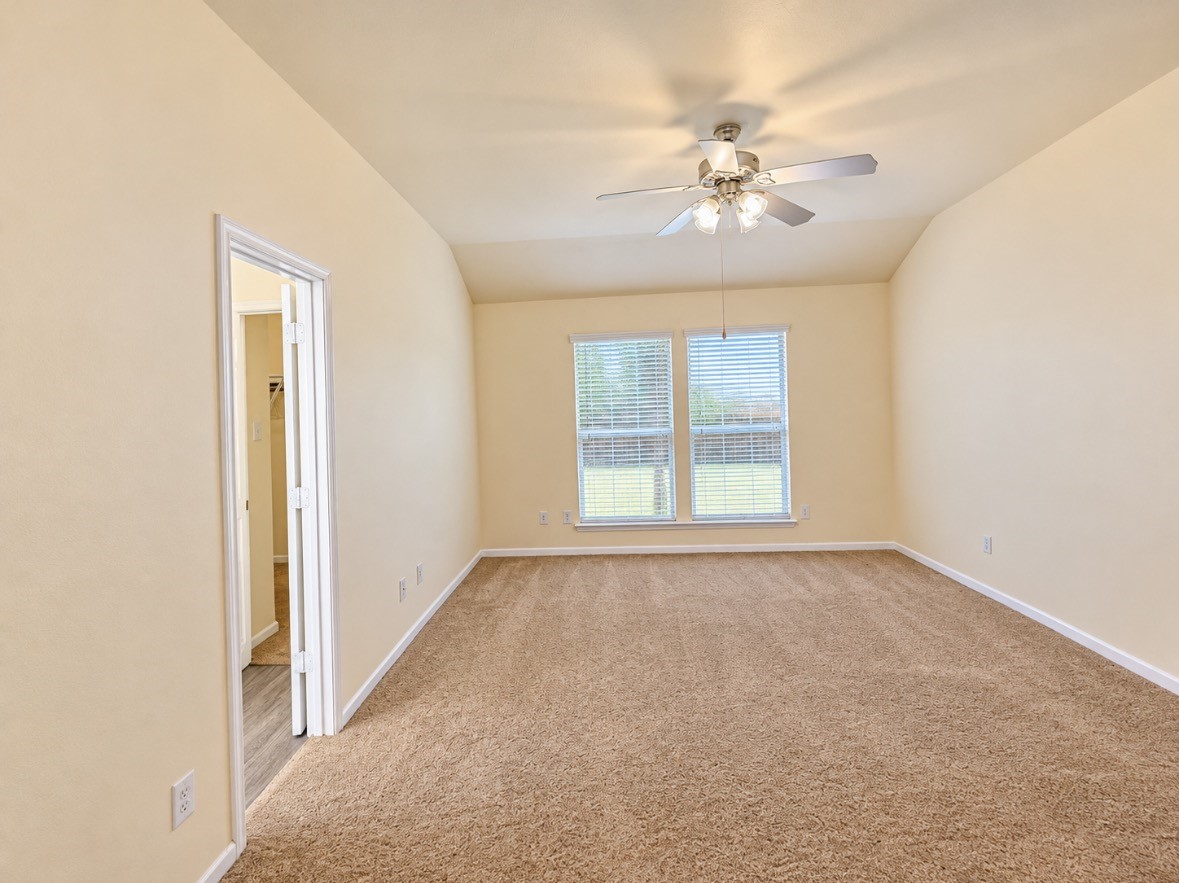 Another view of the oversized primary bedroom, offering endless possibilities for your personal sanctuary.