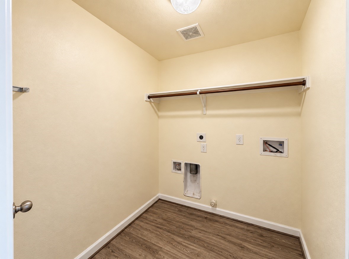 Dedicated indoor laundry room with washer & dryer connections plus overhead storage.