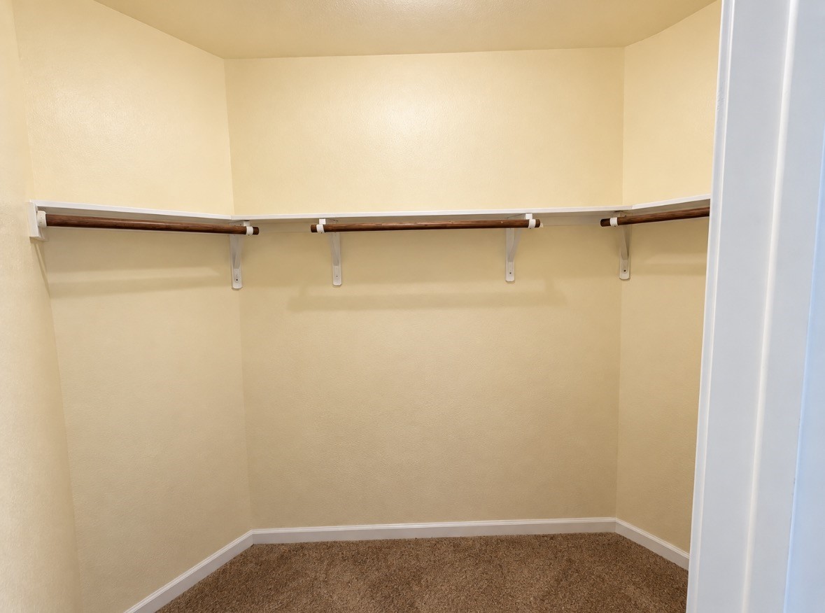 More room for everything! Additional walk-in closet with built-in shelving & hanging space.