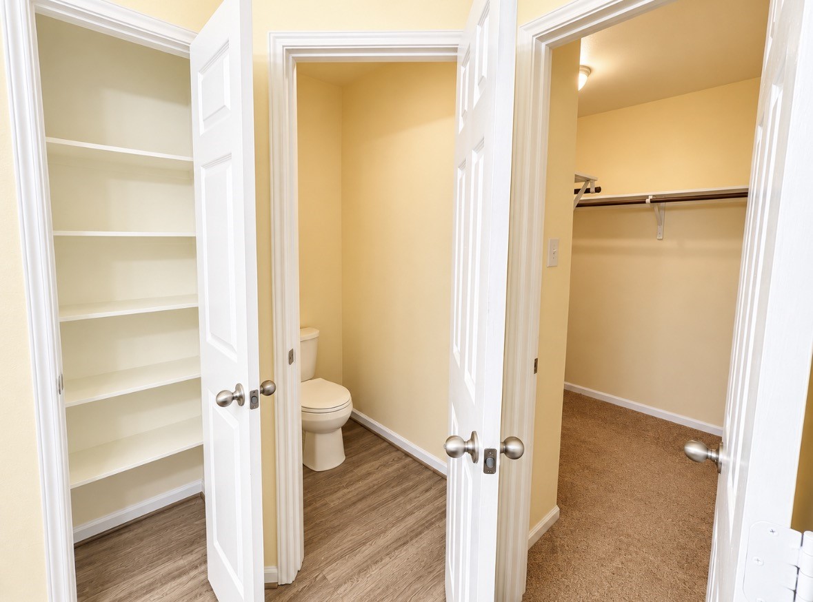 Room for everything! Two closets, built-in shelving & a separate toilet room complete the primary bathroom.