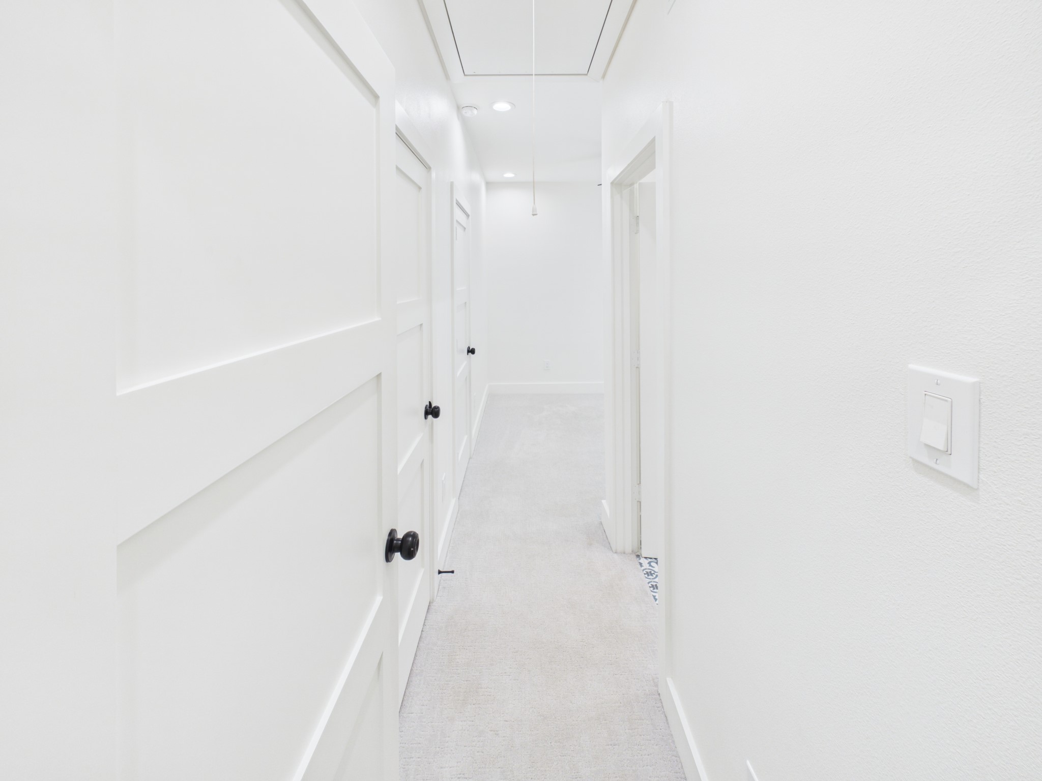 primary bedroom entrance, bathroom on right, double closets on left