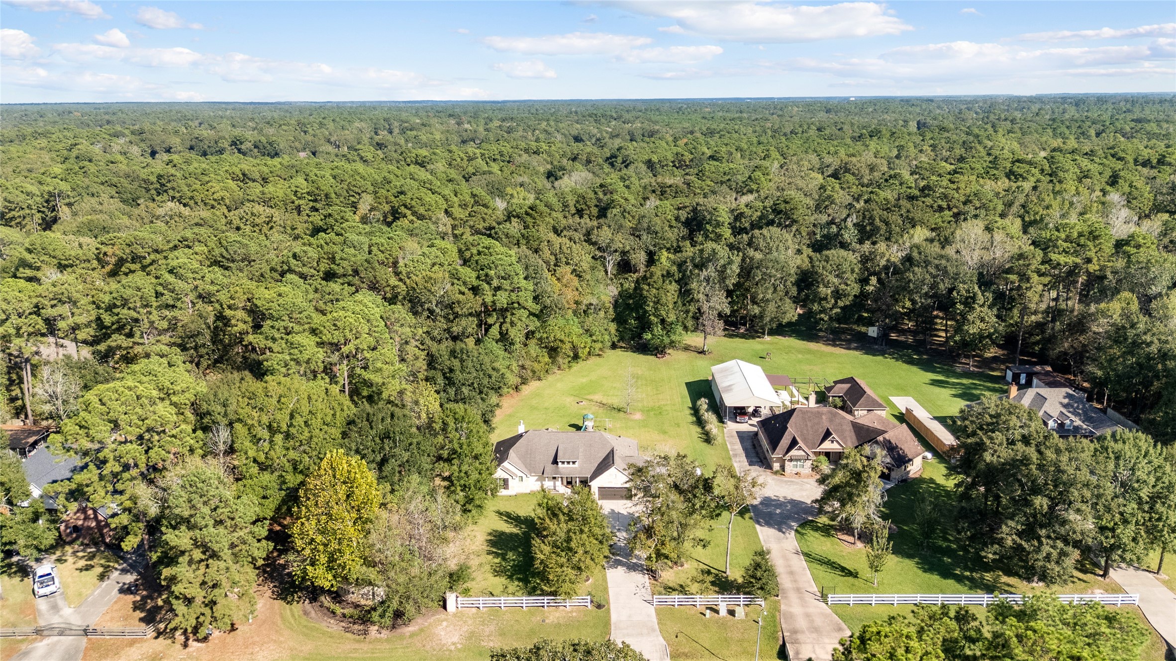 A bird's-eye view of something special! The home sits nestled among mature trees with generous outdoor space to enjoy.
