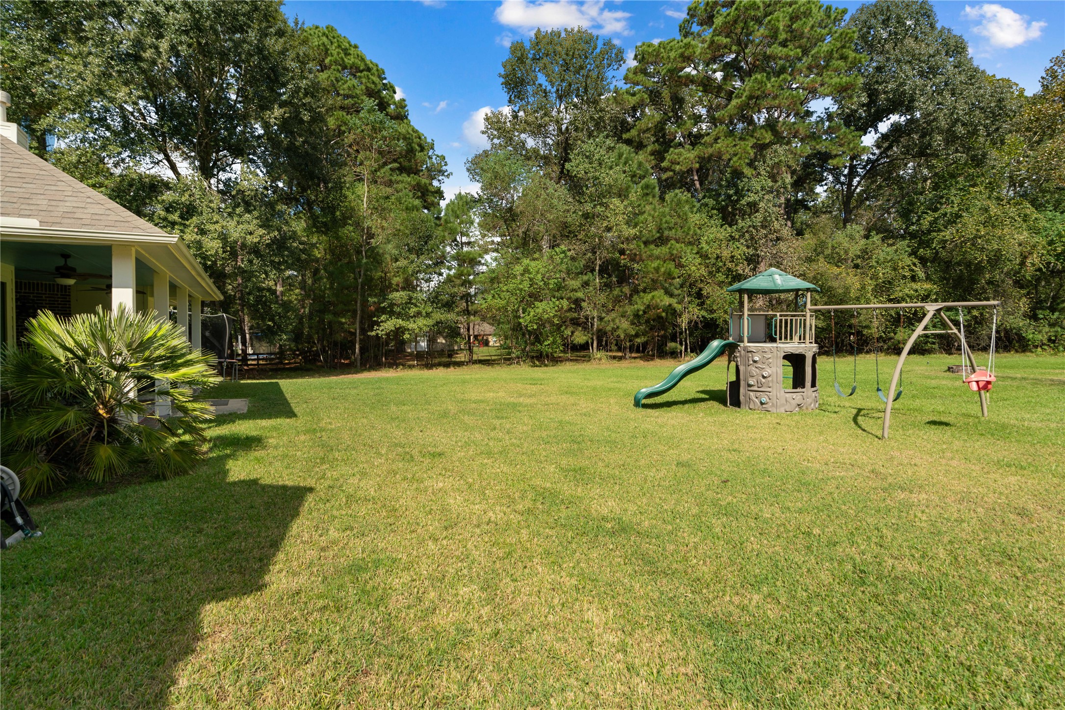 Trade crowded neighborhoods for towering trees and room to roam! This expansive backyard is a breath of fresh air.