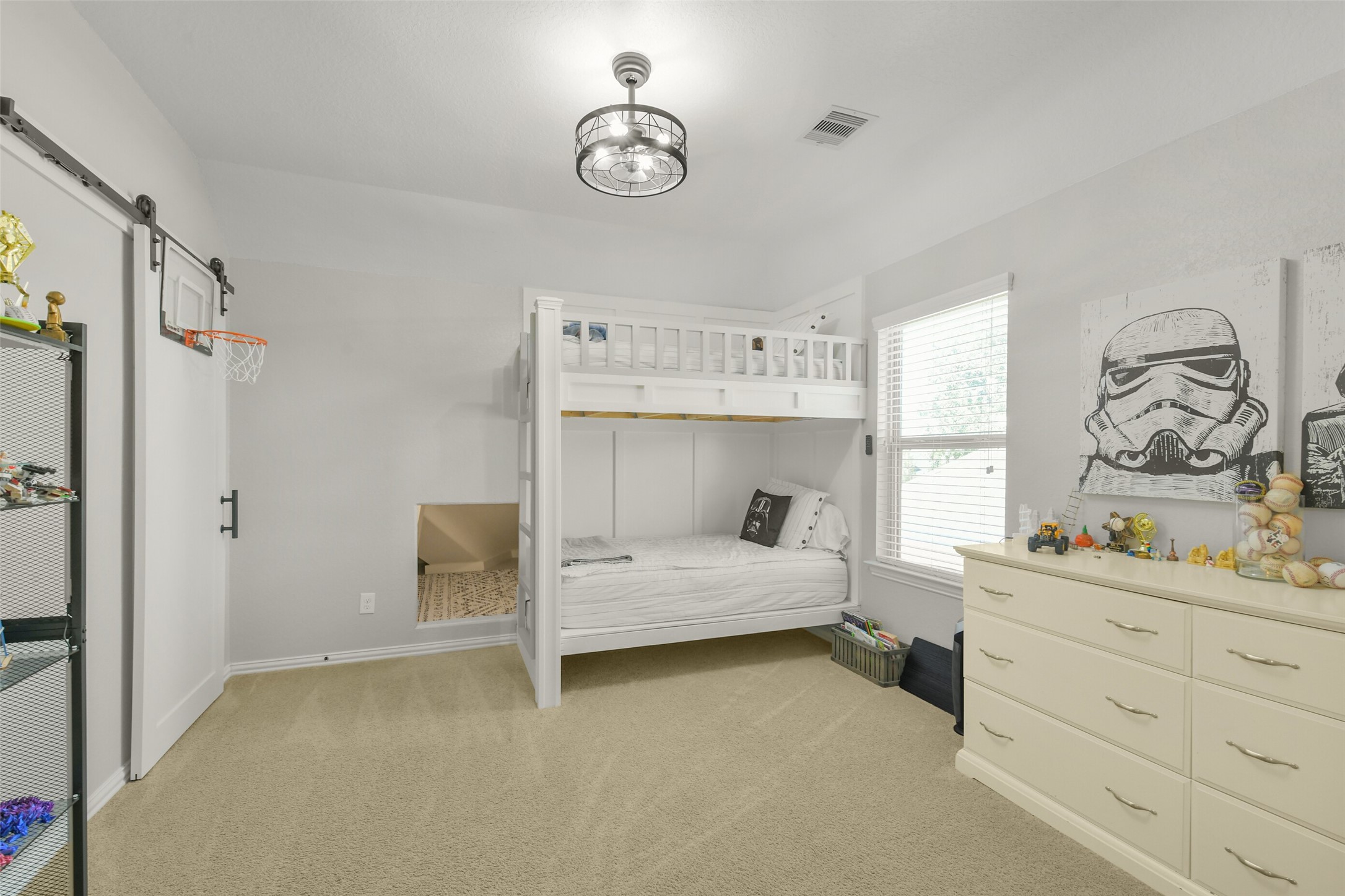 Bright secondary bedroom with neutral finishes and room for a variety of furniture arrangements.
