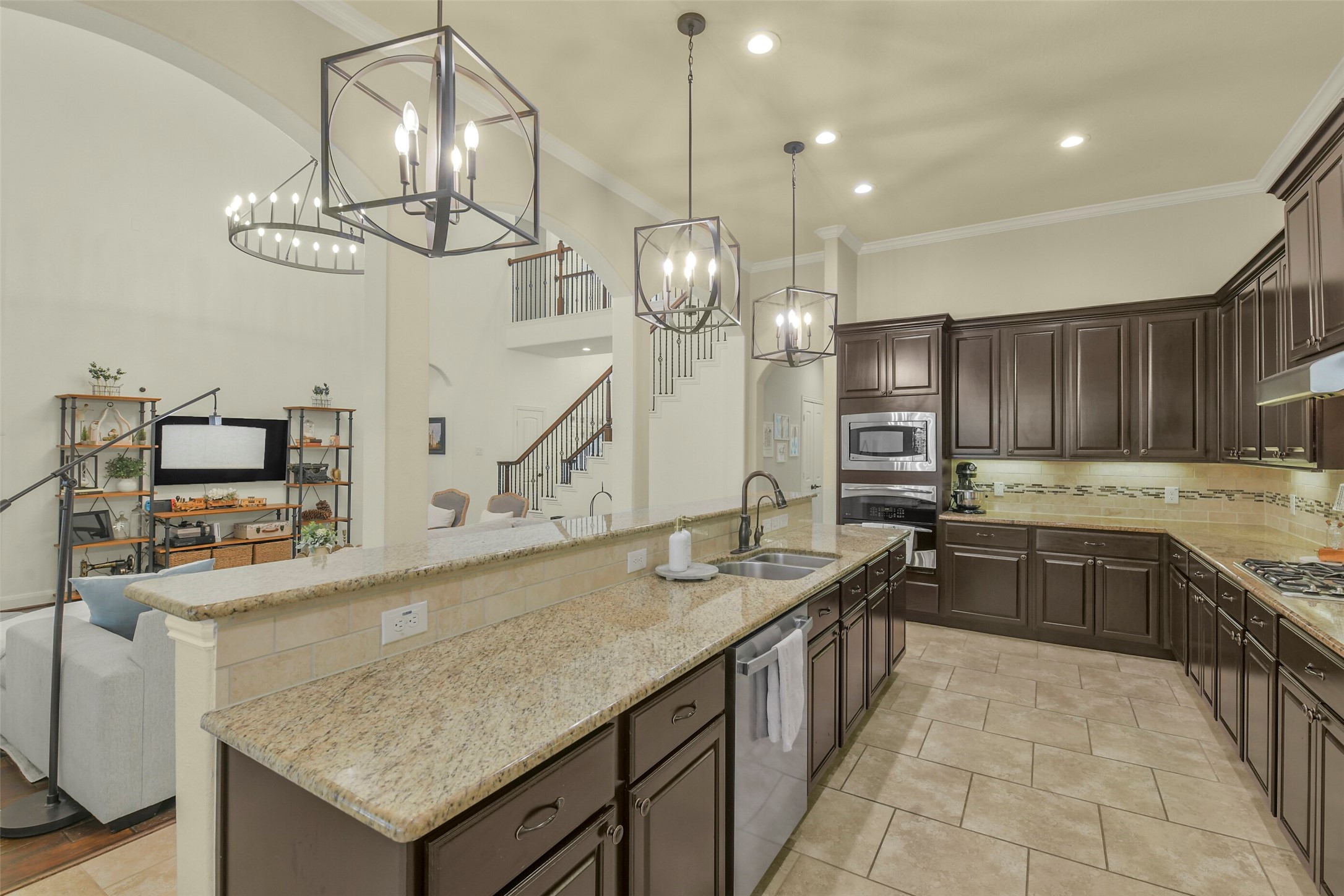Well-appointed kitchen featuring generous counter space, rich cabinetry, and a large center island.