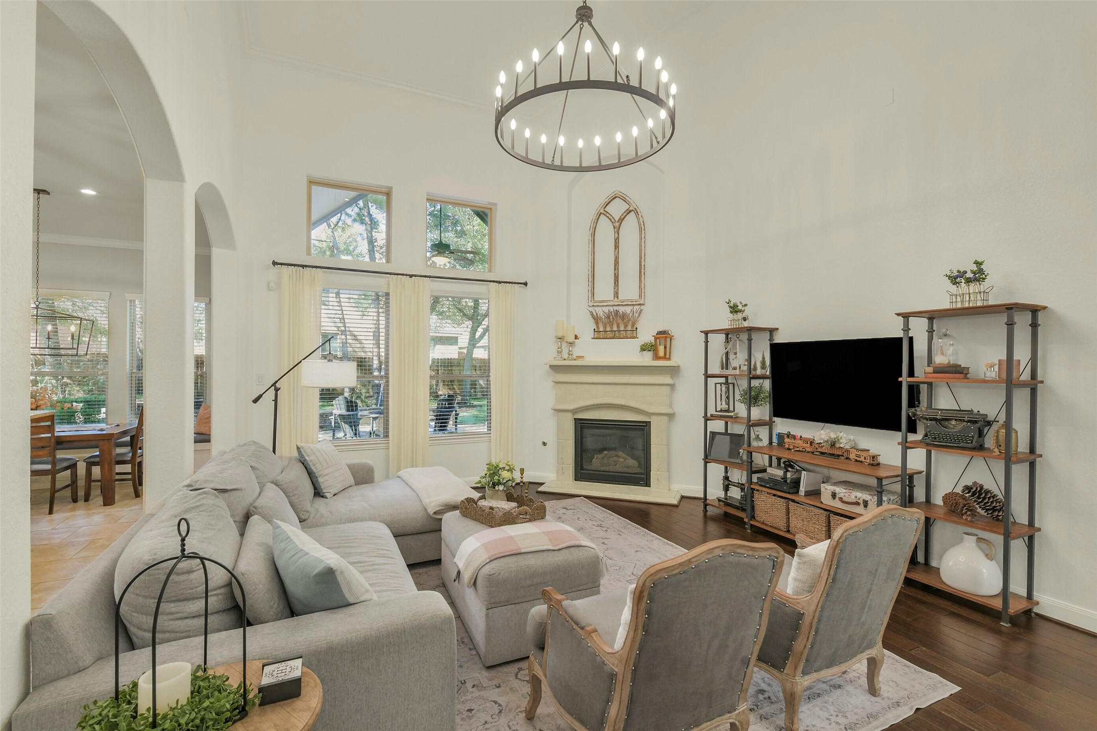 Bright and inviting living area featuring abundant natural light, a fireplace, and generous seating space.