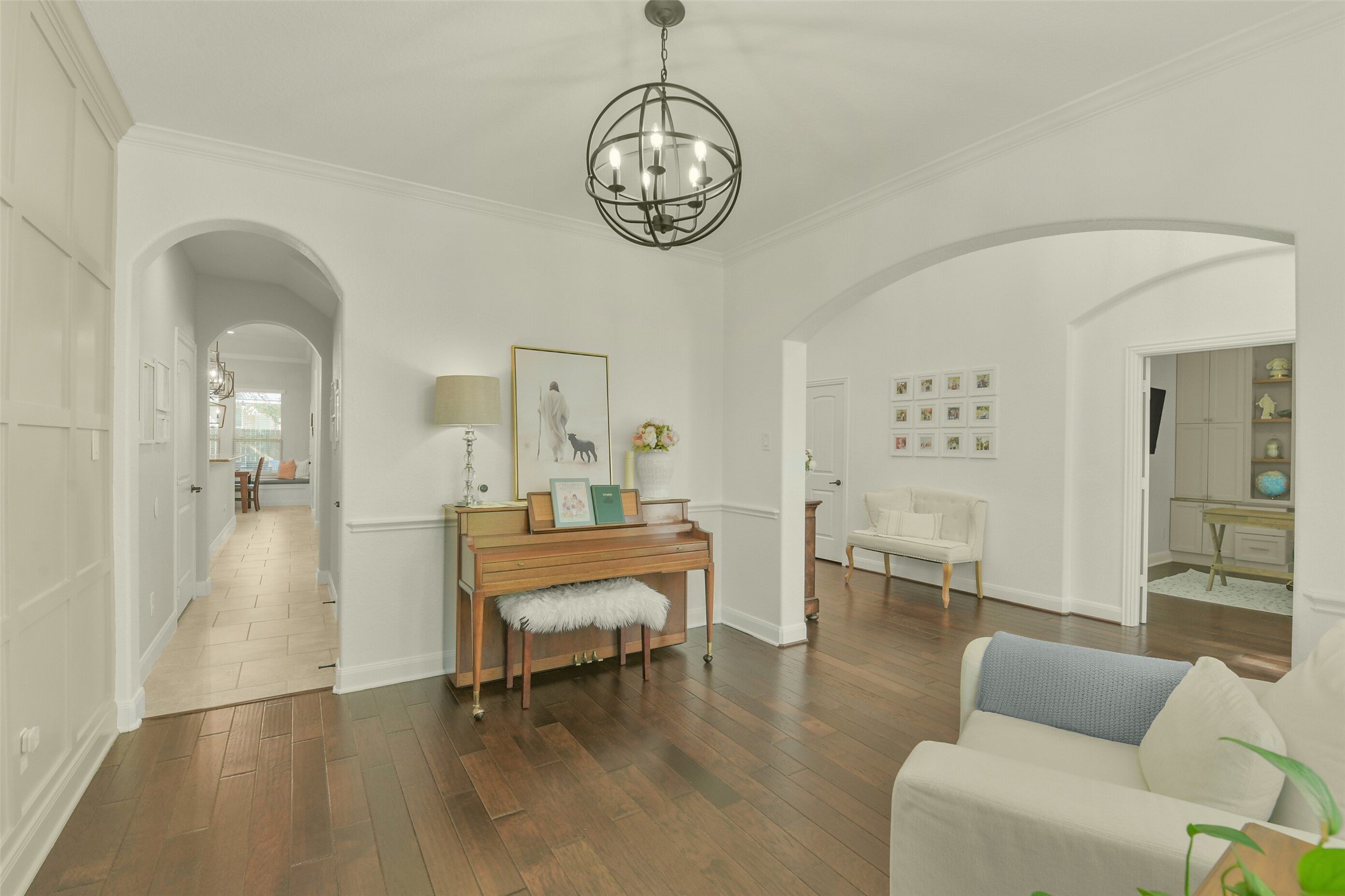 Another view of the primary suite showcasing its generous proportions and beautiful flooring.