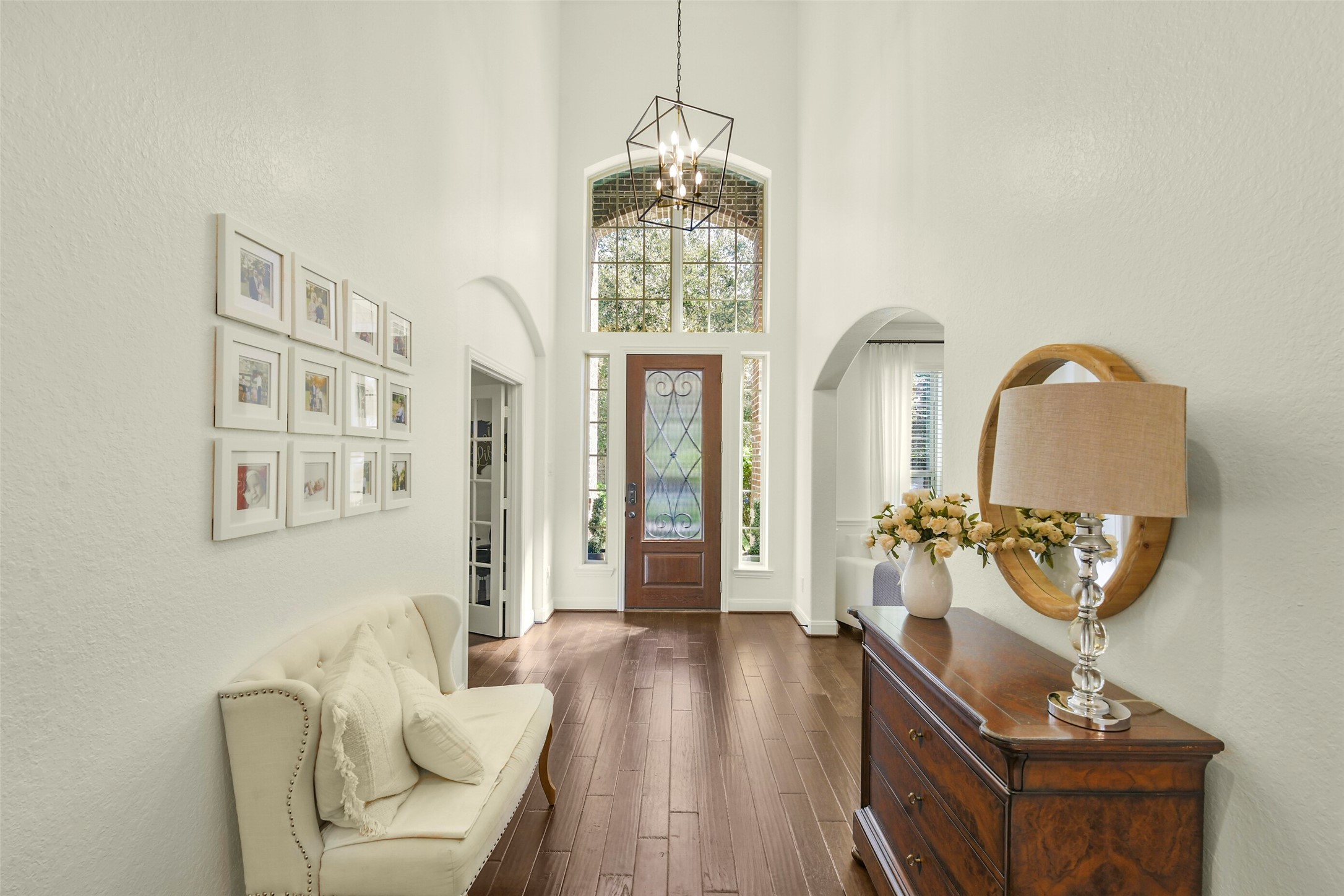 Light-filled foyer with high ceilings, decorative lighting, and beautiful architectural details.