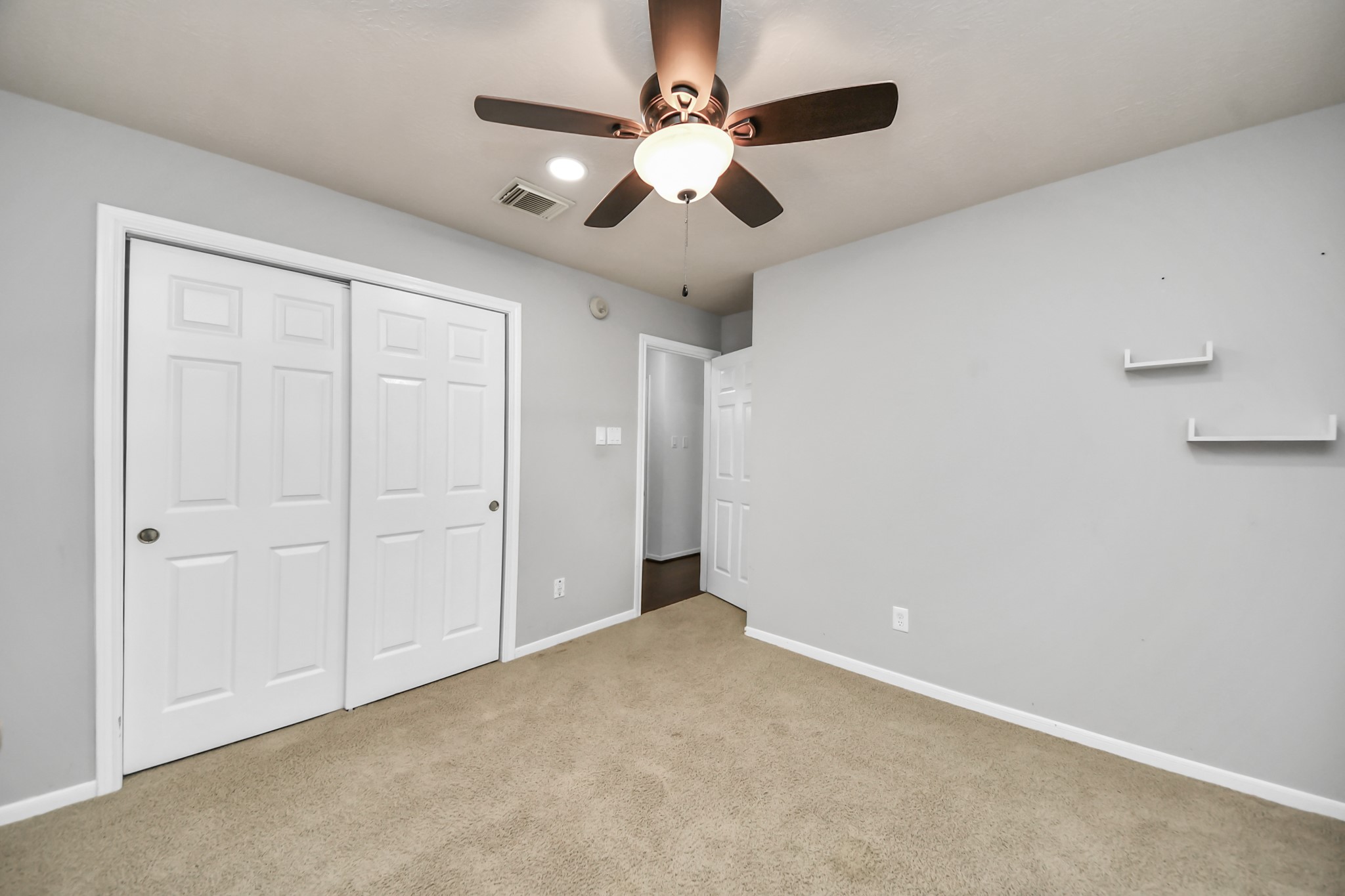 Another view of the secondary bedroom showing the closet and room for your furniture.