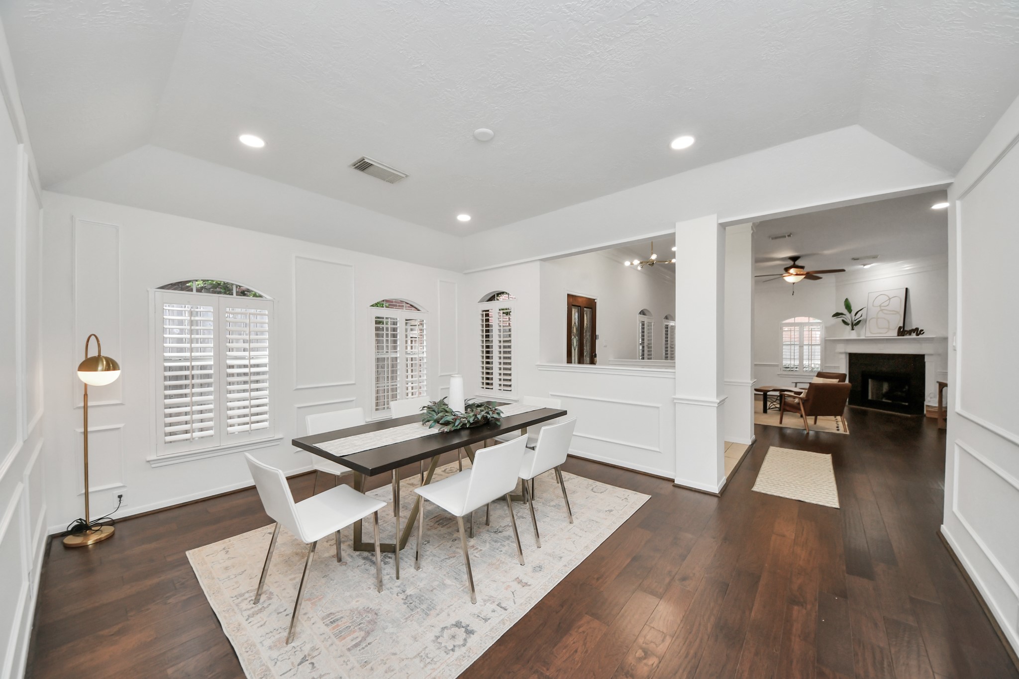 Another view of the dining room, with the entry and living room just beyond. The rooms feel connected while still having their own space.