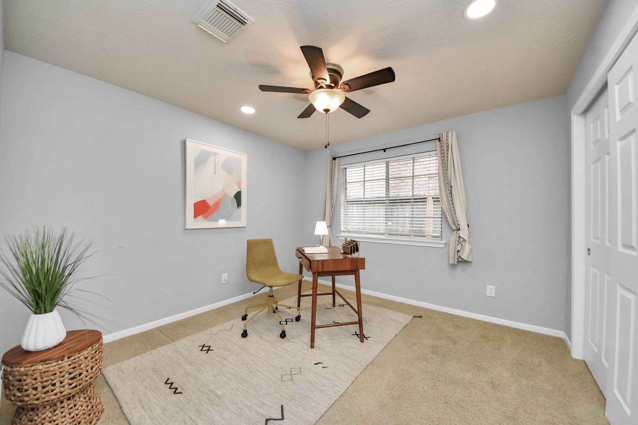 This secondary bedroom is currently set up as an office, a flexible space to use however you need.