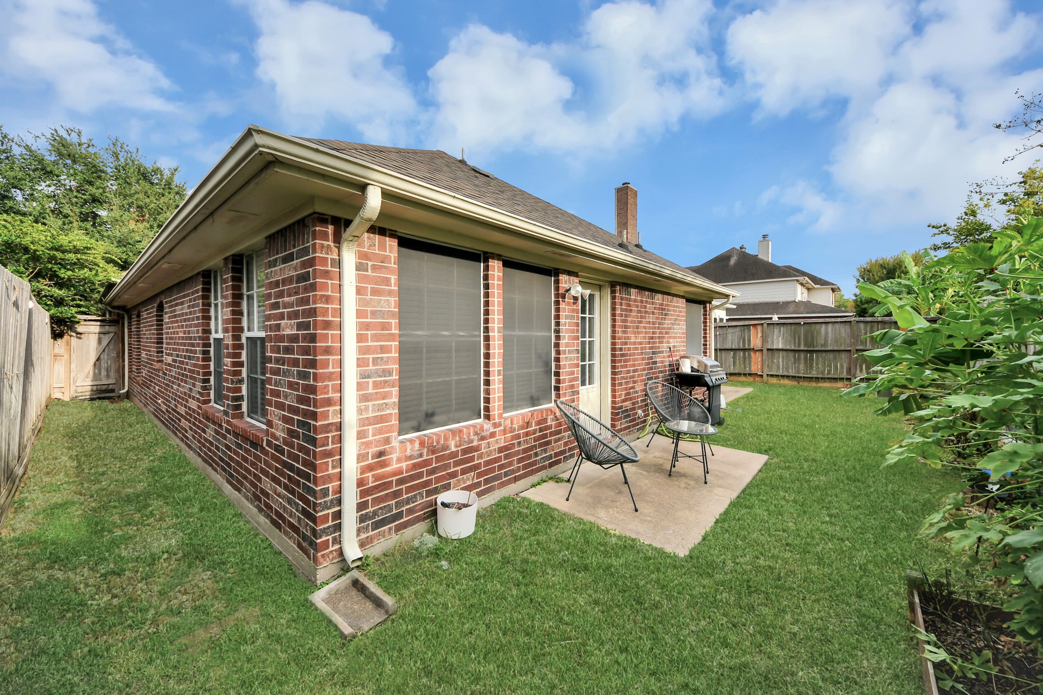 A low-maintenance backyard with a patio for your morning coffee or relaxing outside, plus space for a grill.