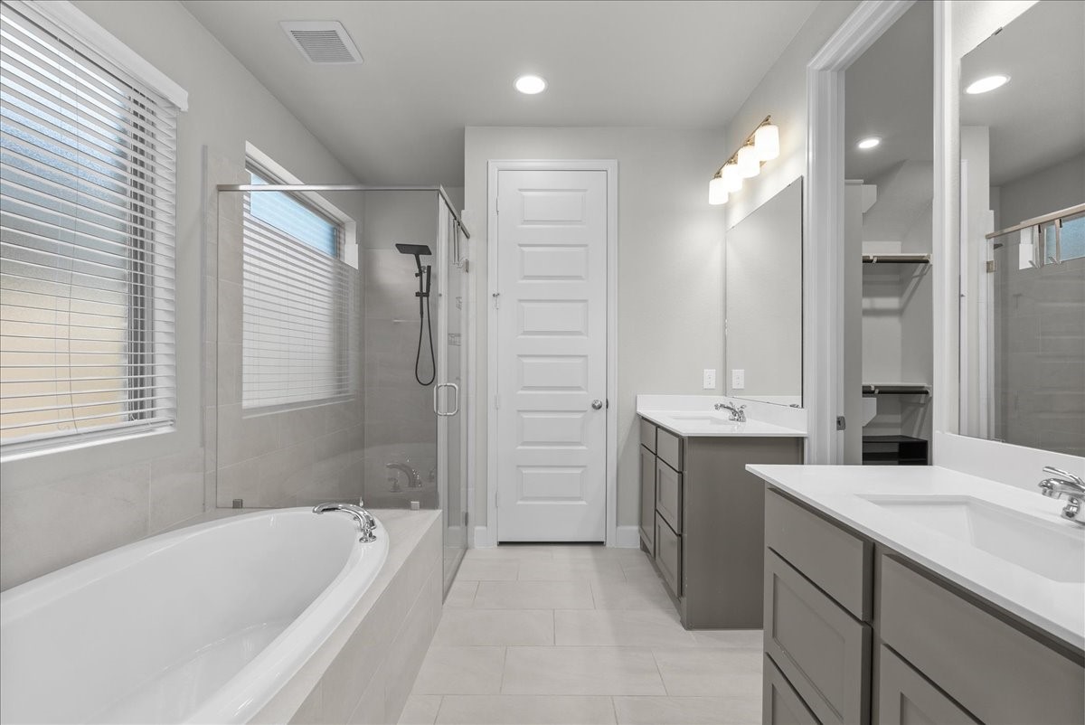 Primary ensuite bathroom with a nice spa like shower and soaking tub.