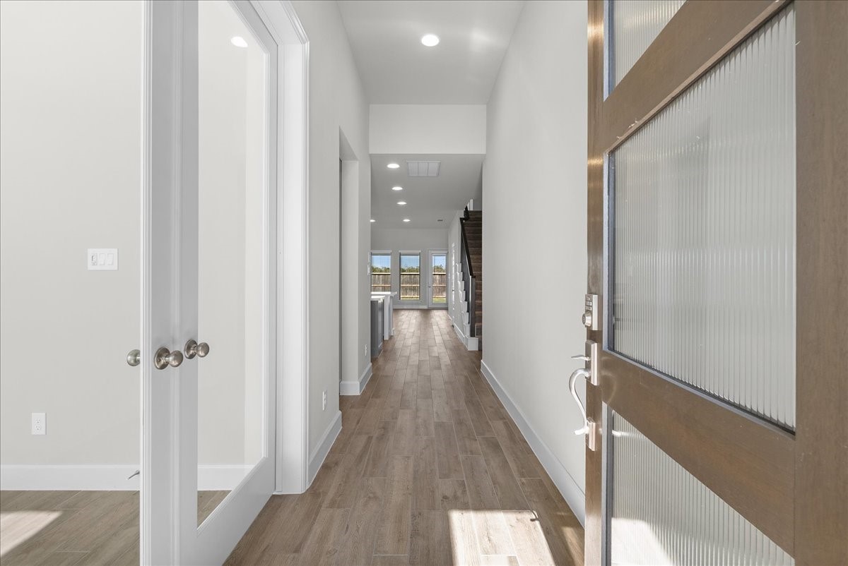 Enter into an inviting entry where working from home is quiet and peaceful on the left.