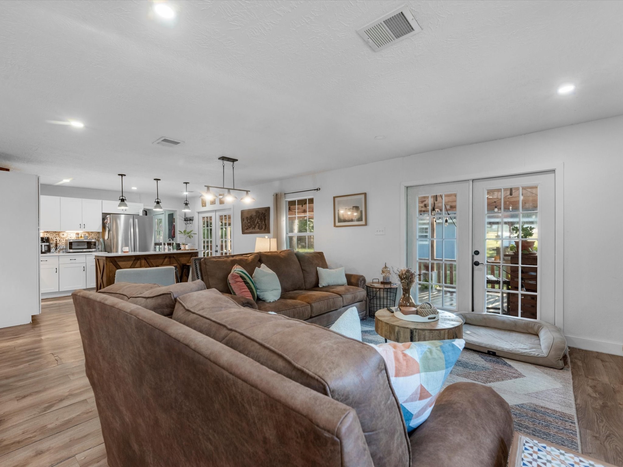 Open-concept living area flowing seamlessly into the kitchen and dining space, creating a spacious layout ideal for everyday living and entertaining.