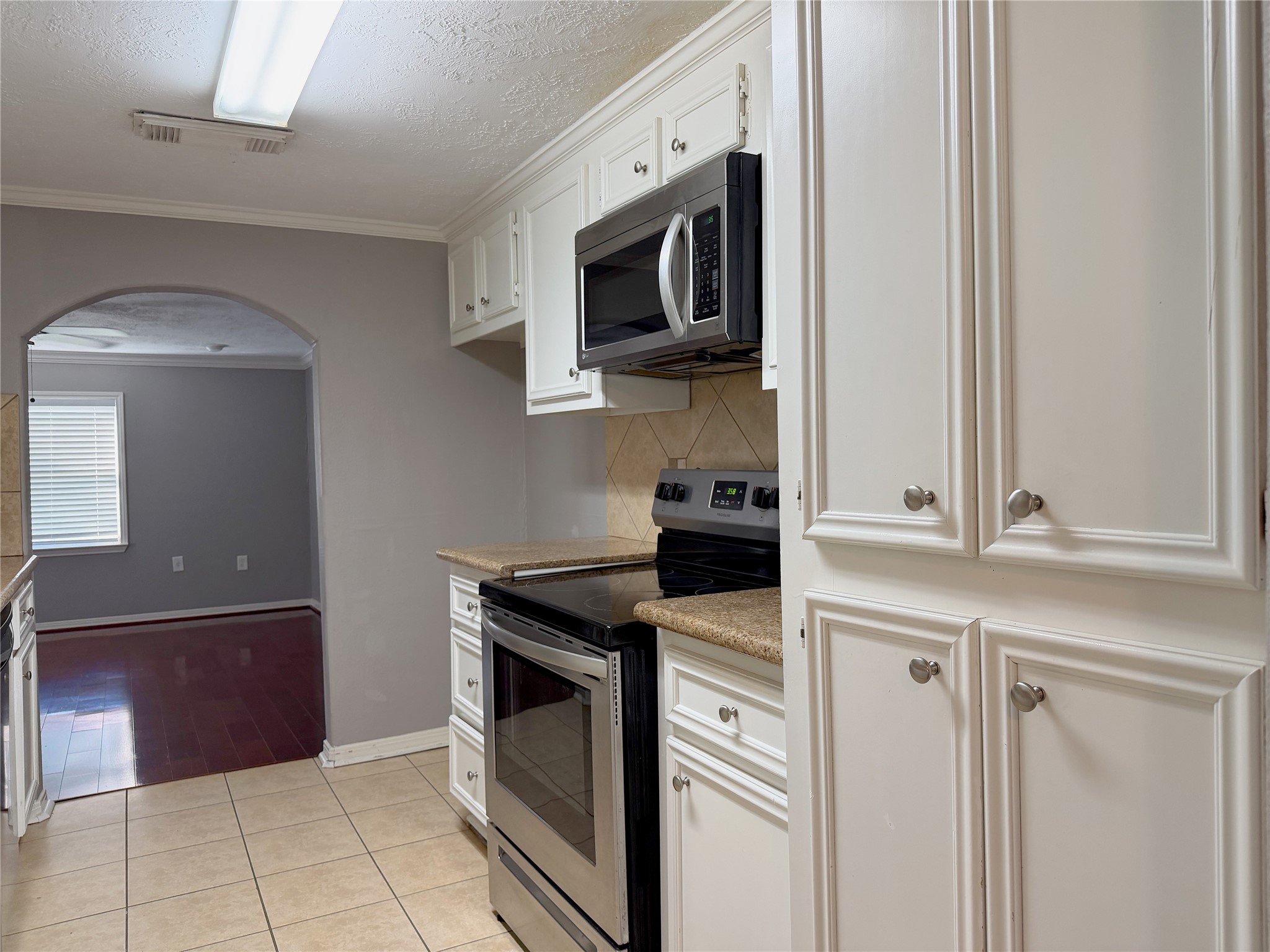 Functional galley kitchen features a streamlined design with ample workspace and easy access between the cooking, prep, and storage areas.
