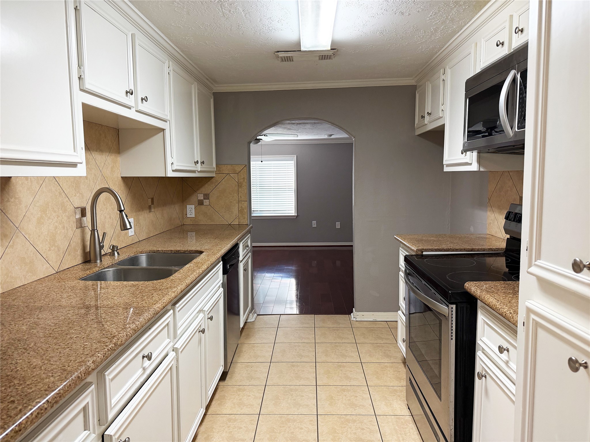 Galley-style kitchen offers an efficient layout with cabinetry and counter space along both sides for convenient meal preparation and storage. Galley-style kitchen offers an efficient layout with cabinetry and counter space along both sides for convenient meal preparation and storage.
