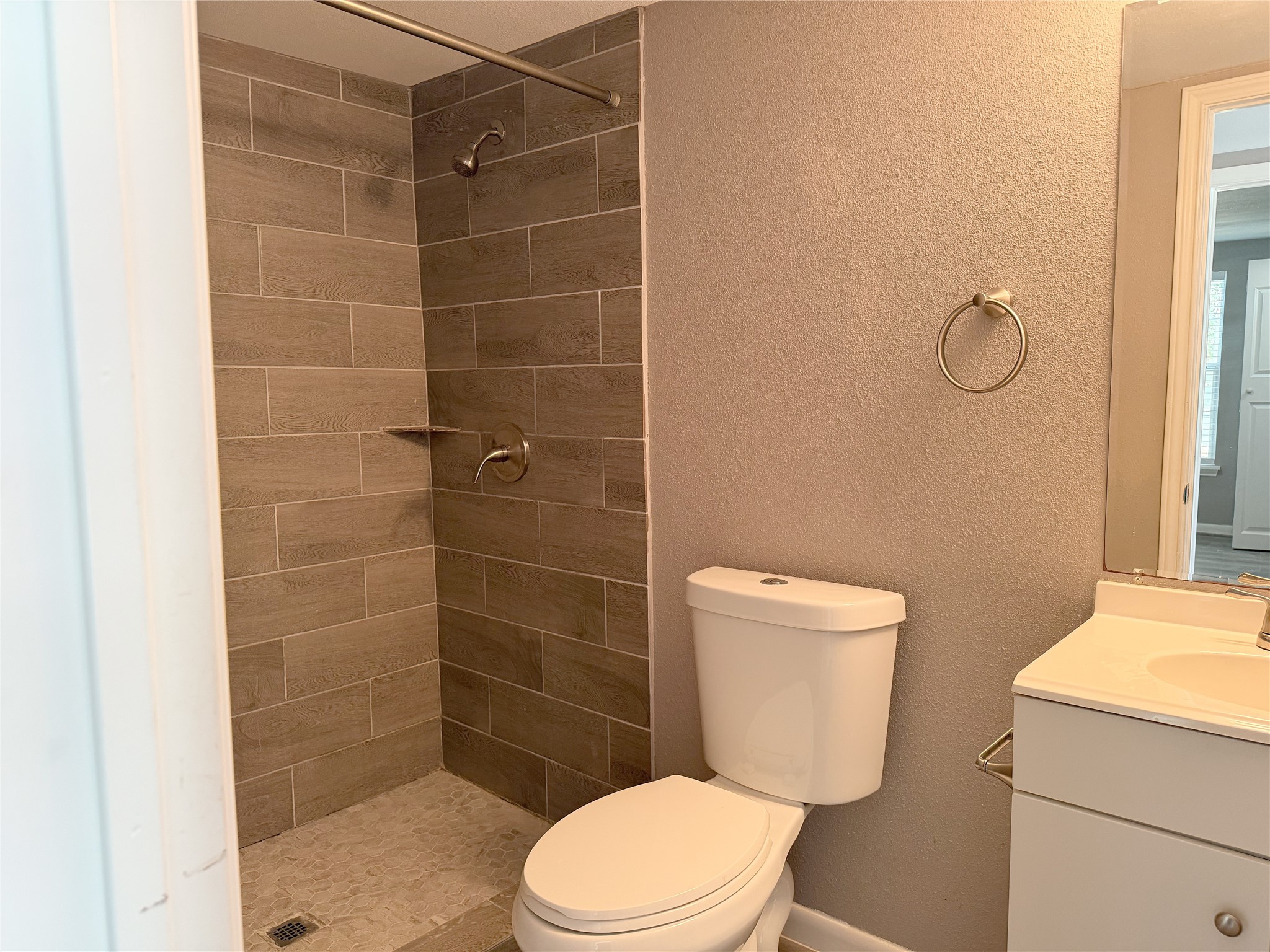 Compact bathroom in the garage apartment offers the essential fixtures in a functional layout.
