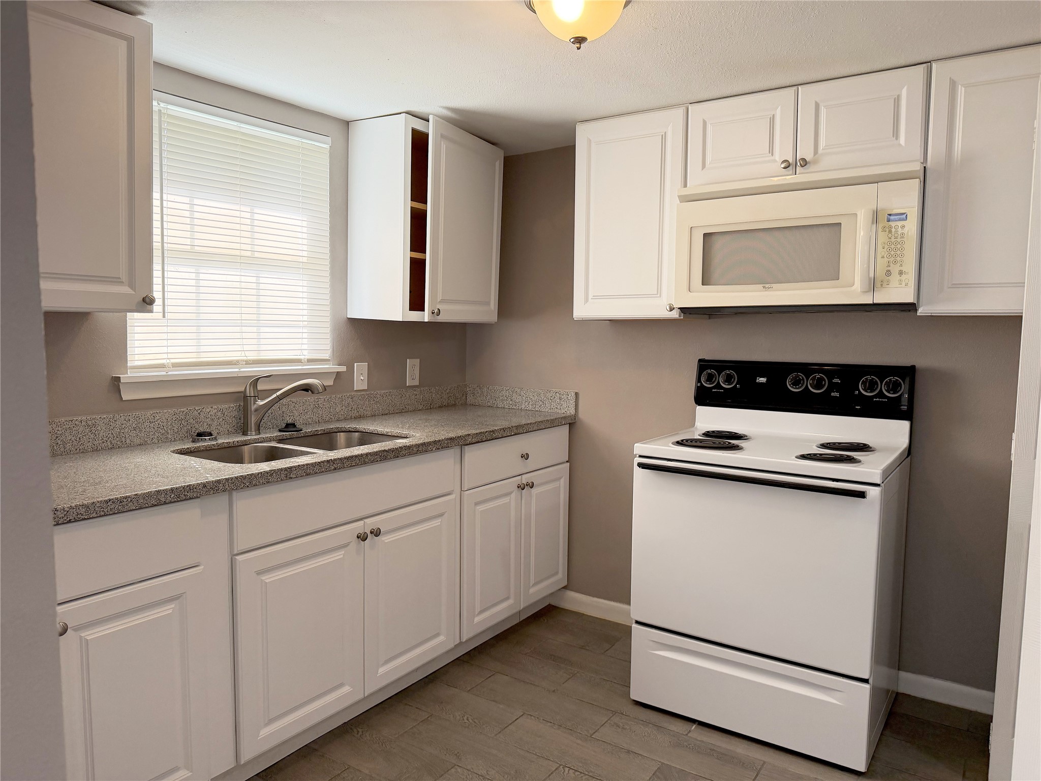 Garage apartment features a functional kitchen and laundry area combined into one convenient space for everyday use.