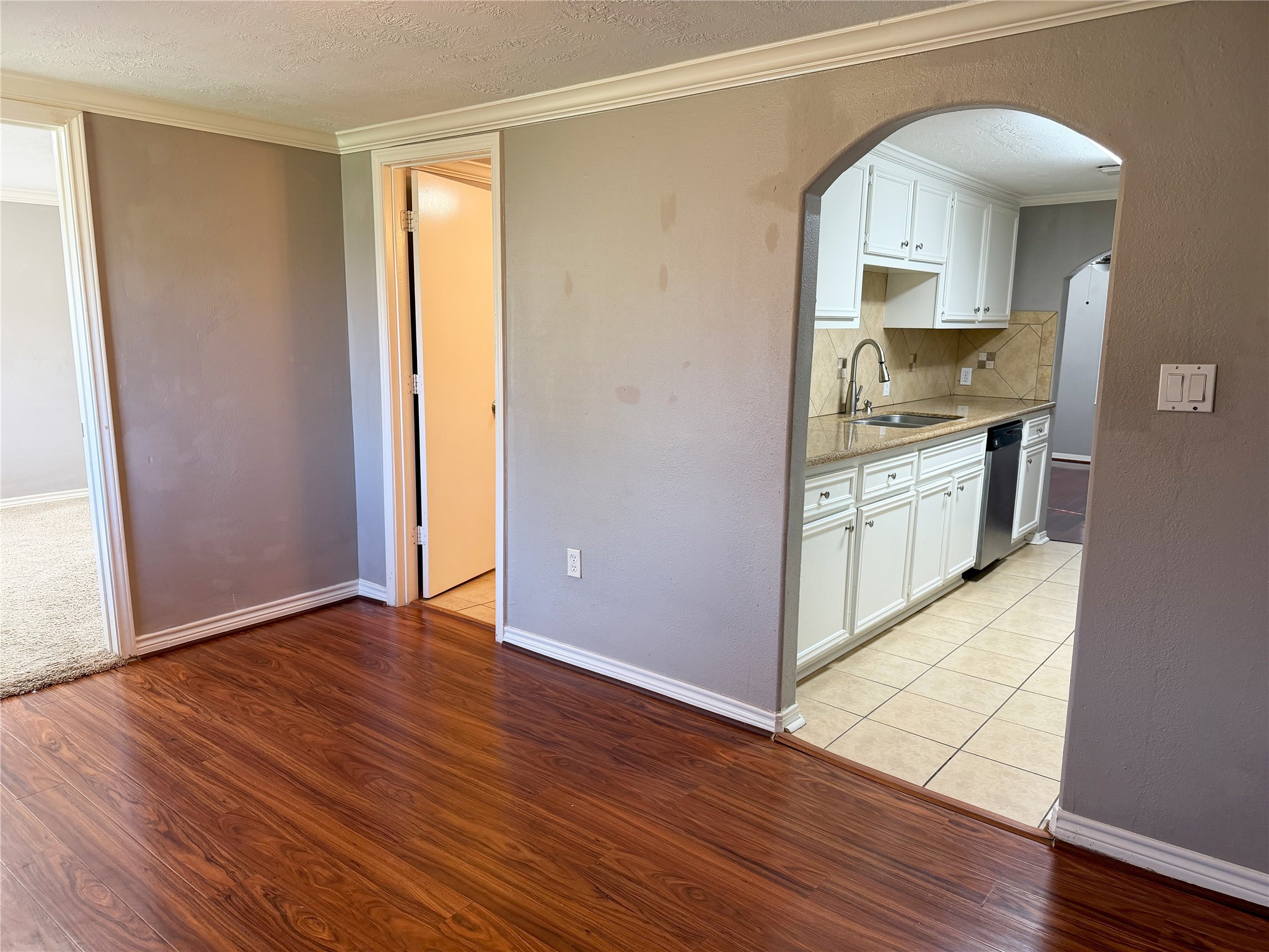 Versatile front room with laminate flooring serves as a central transition space connecting to multiple areas of the home. Versatile front room with laminate flooring serves as a central transition space connecting to multiple areas of the home.