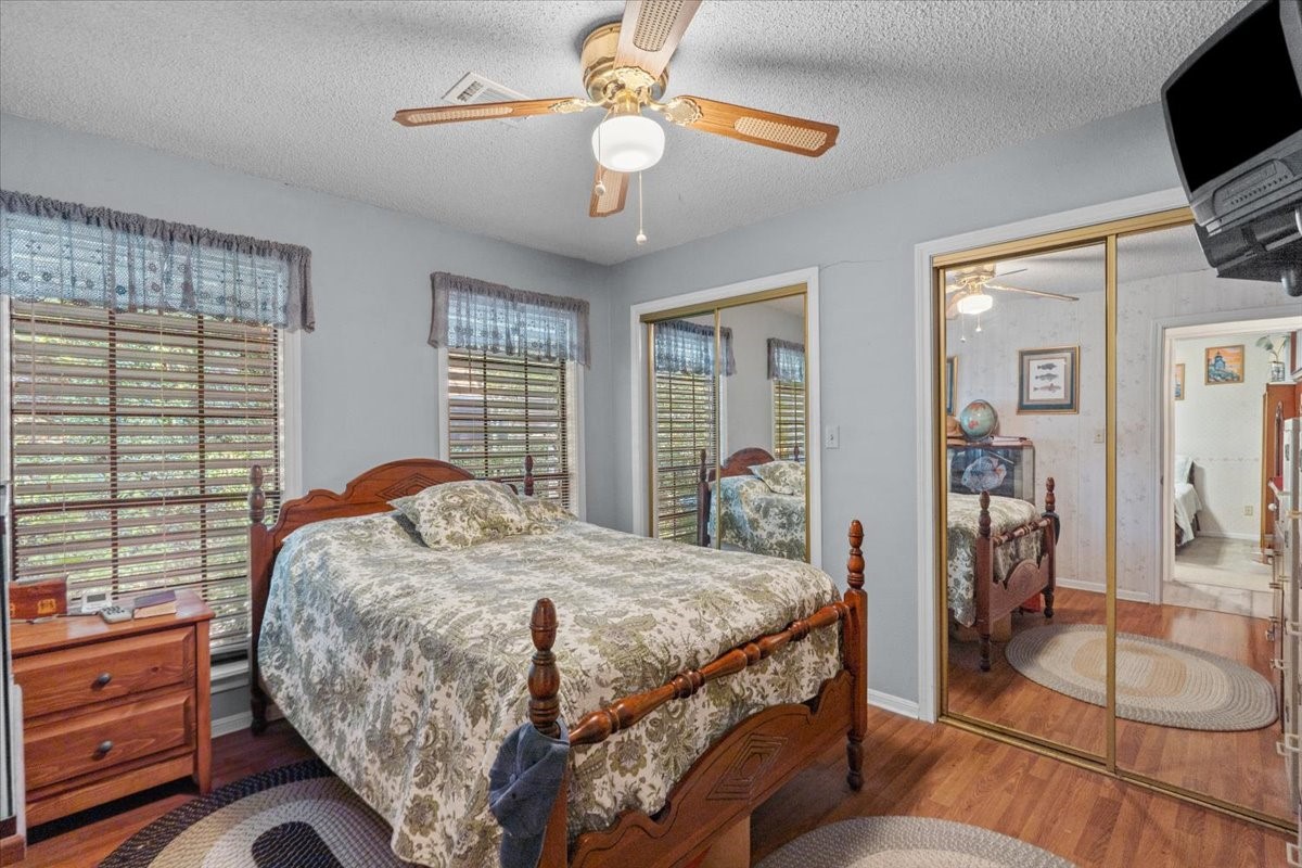 Secondary bedroom with double closets and vinyl flooring.