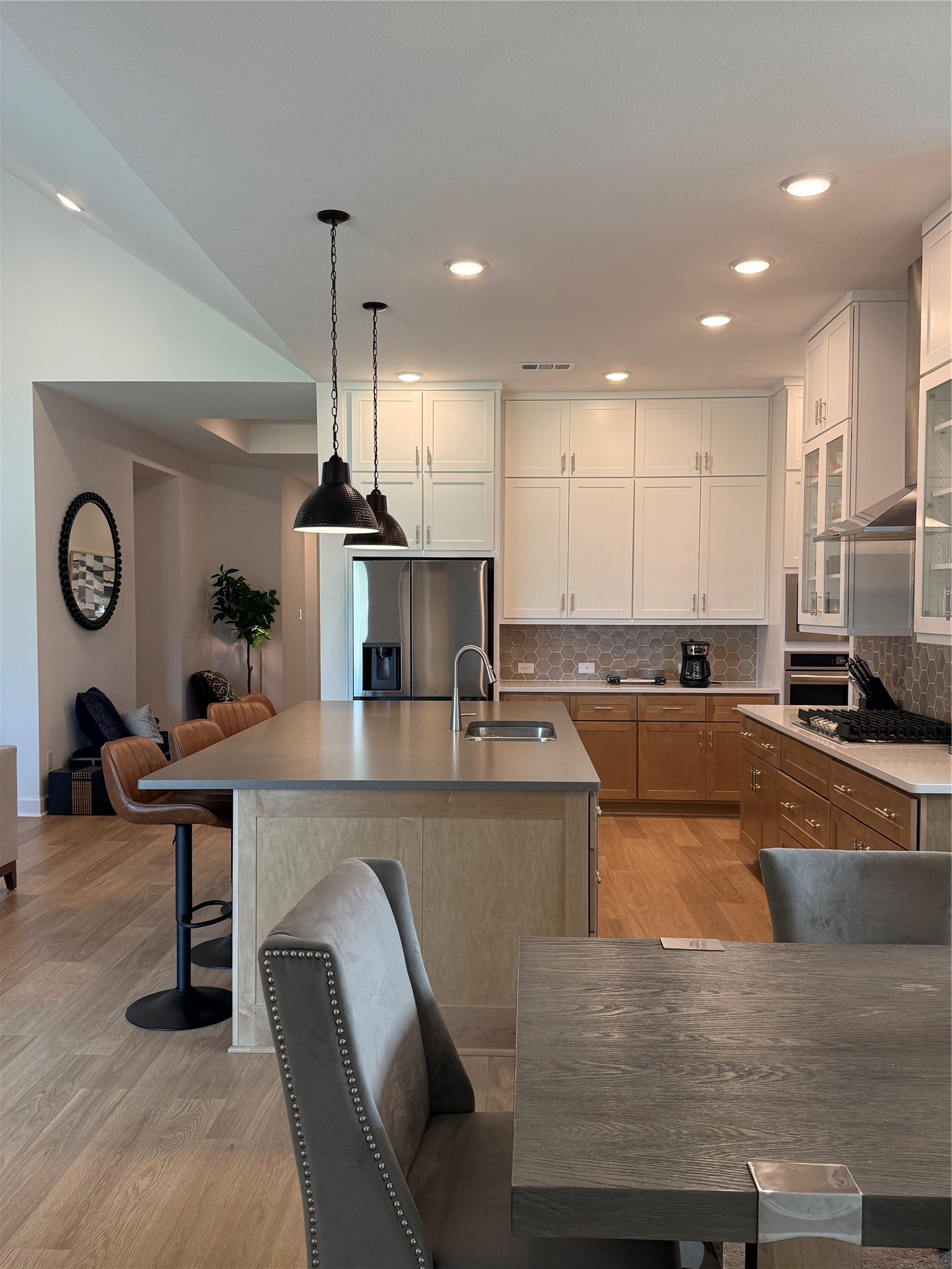 Modern kitchen with sleek cabinetry, a spacious island with bar seating, and smart pendant lighting.