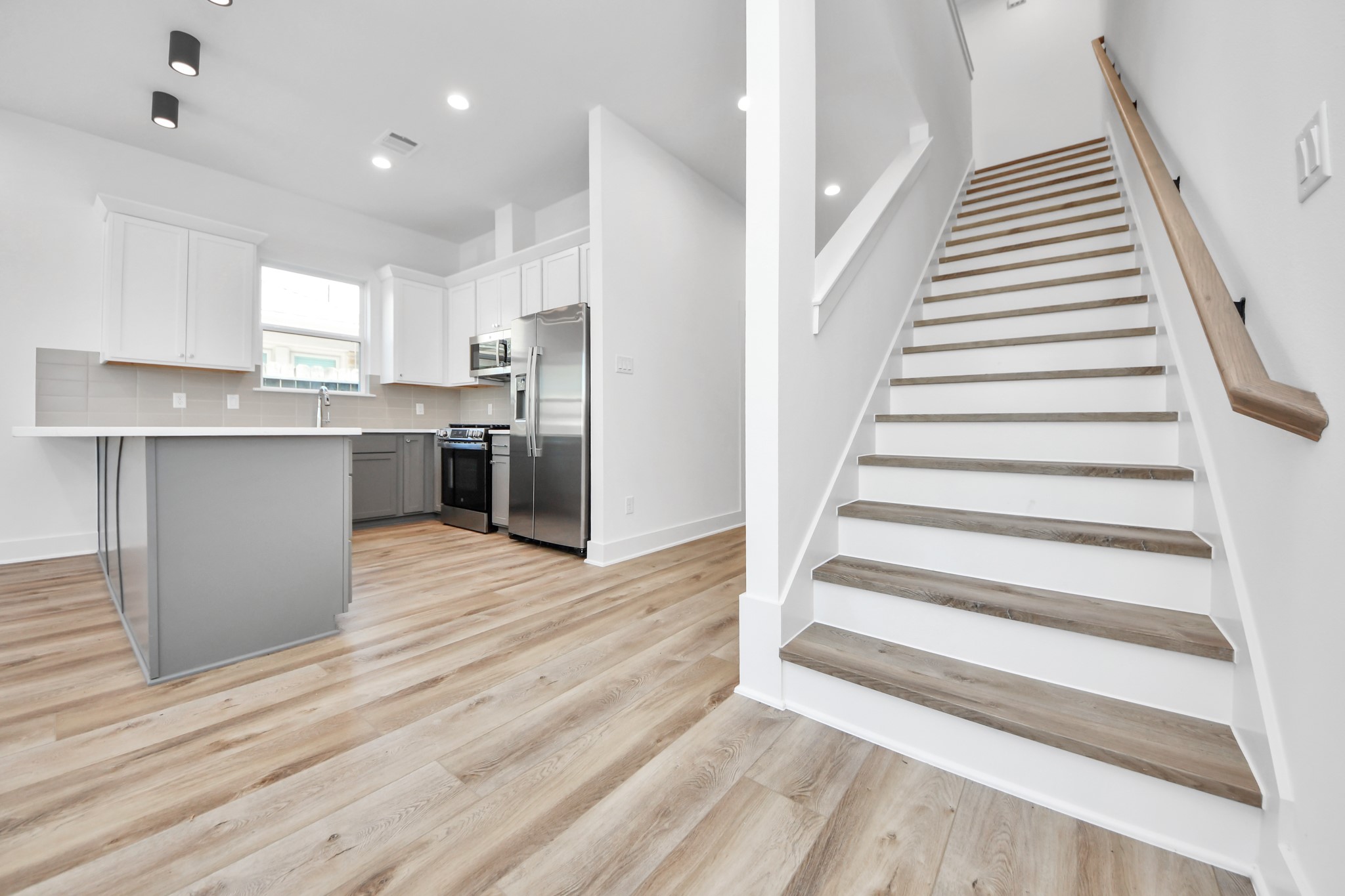 Unit B kitchen and staircase leading to the second floor.