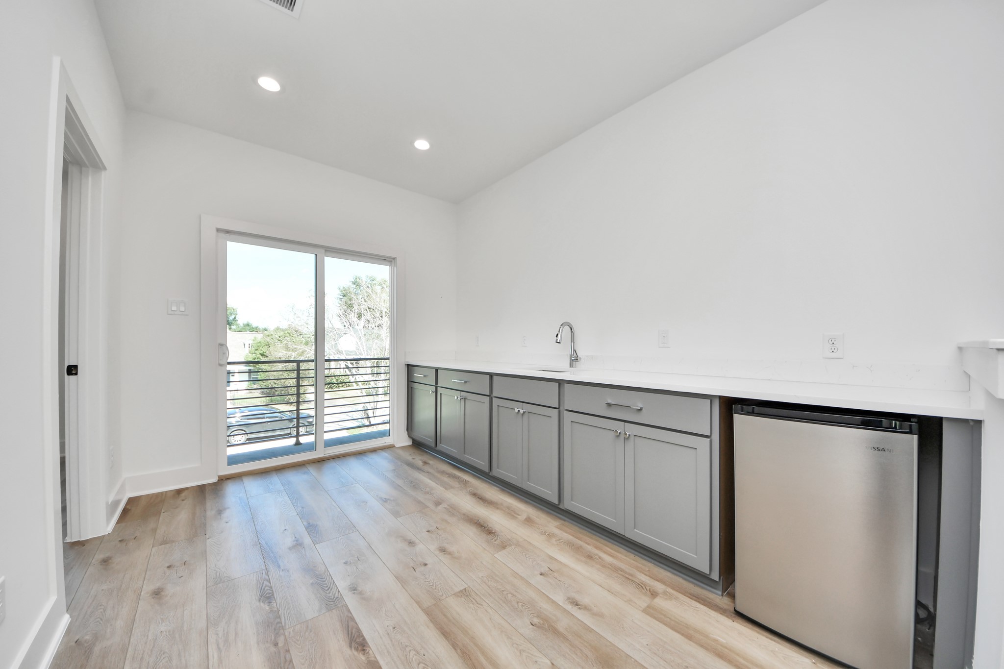 Unit A upstairs wet bar with countertop space, sink, and beverage refrigerator.