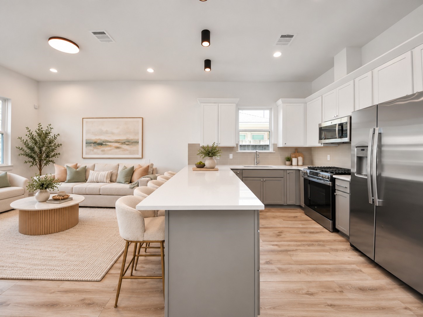 Unit B kitchen with a spacious island, open to the living area.**Virtually staged
