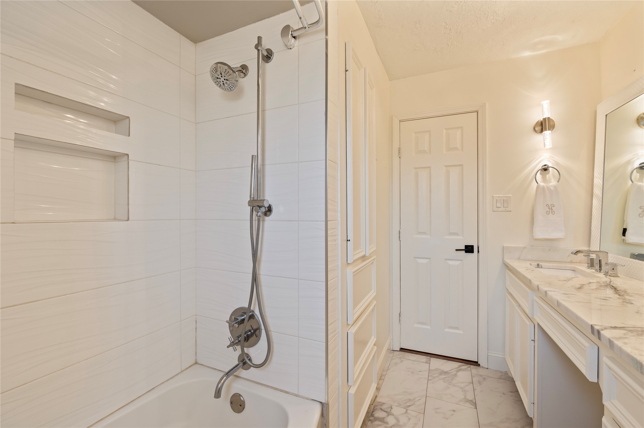 Shower/tub combo with tiled walls in the secondary bath.