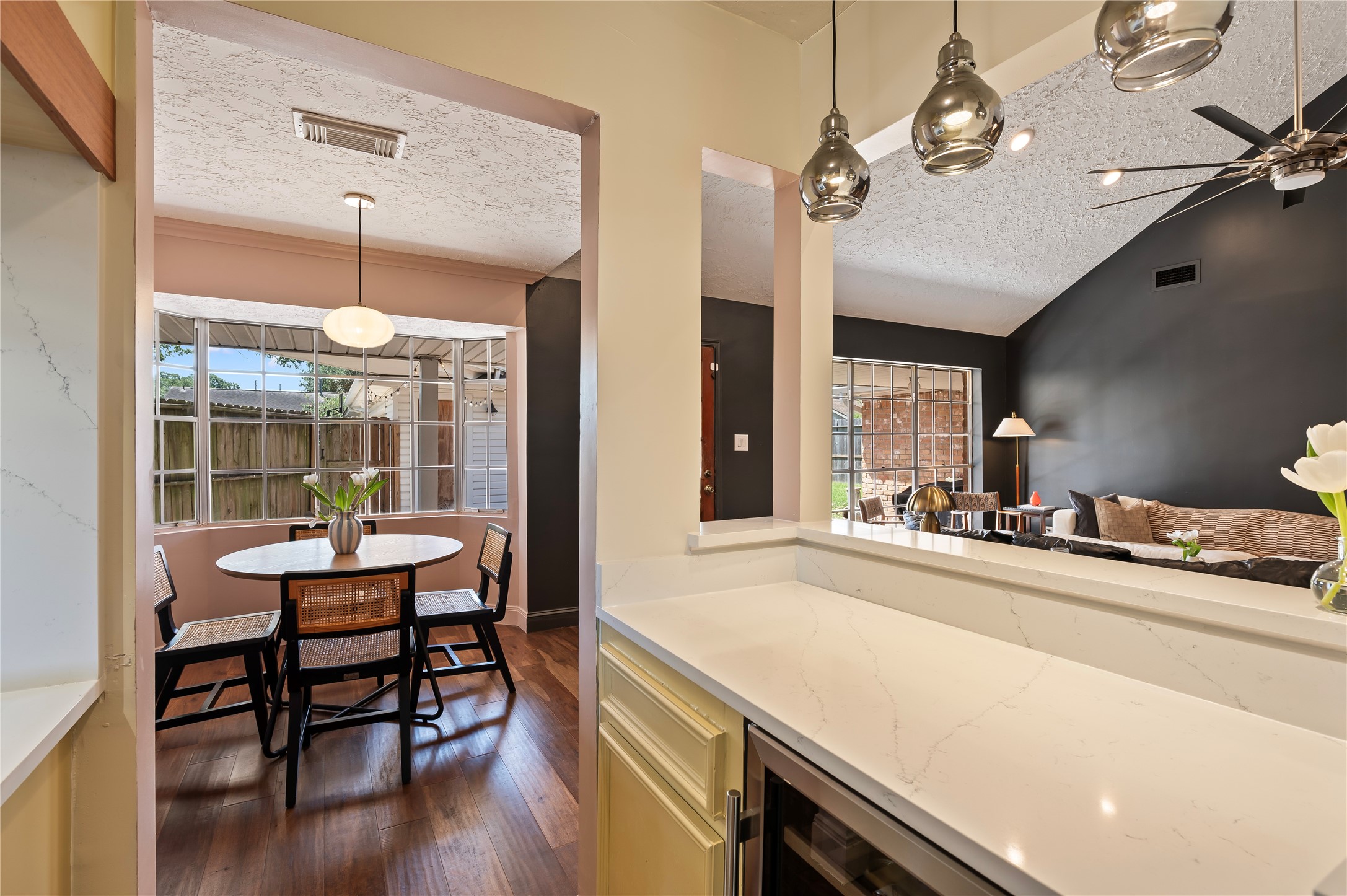 Bar area with custom light fixtures leads to the breakfast area.