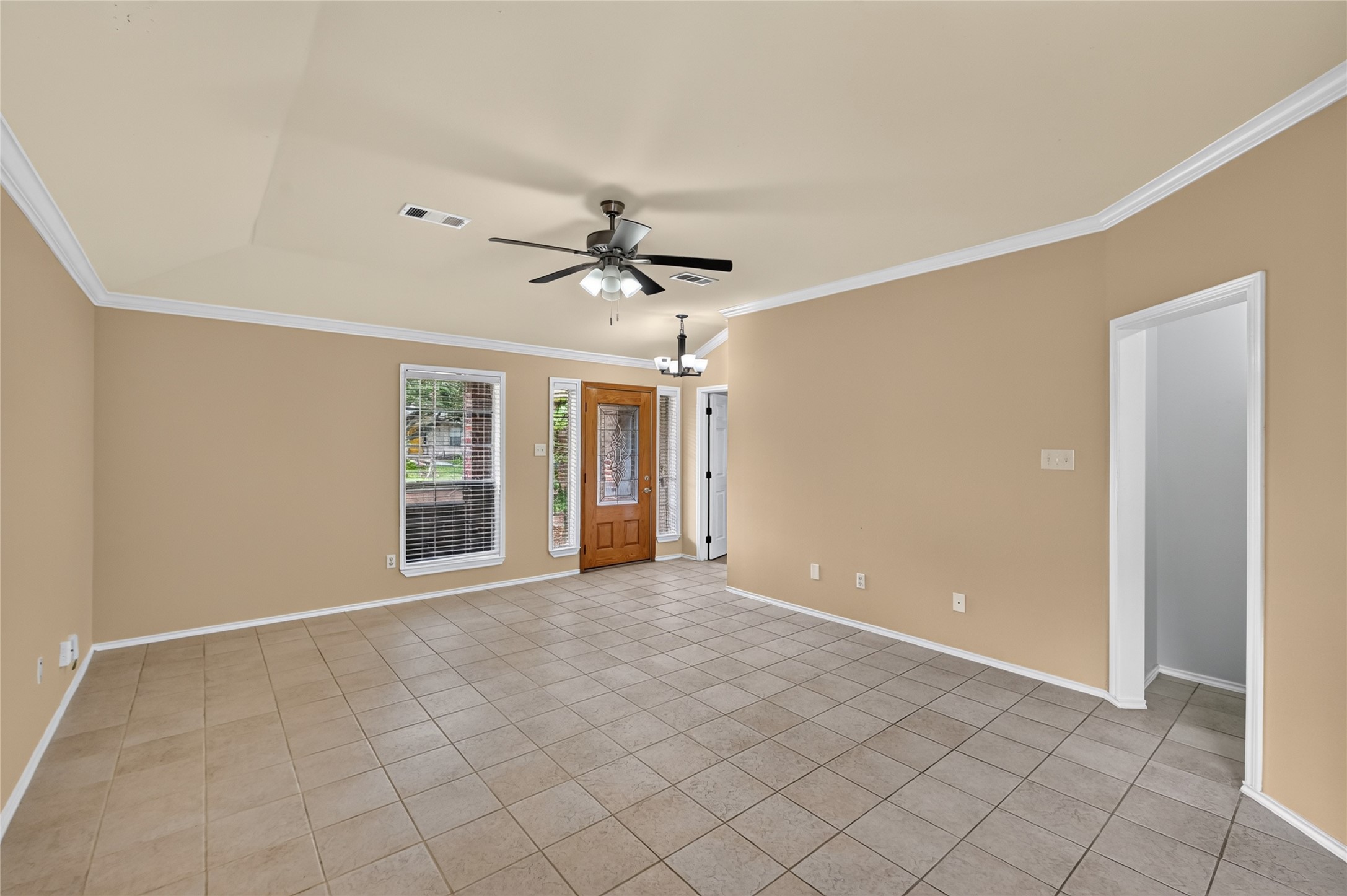 The front door opens to the living
room, secondary bedroom to the
left and hallway to the other two
bedrooms