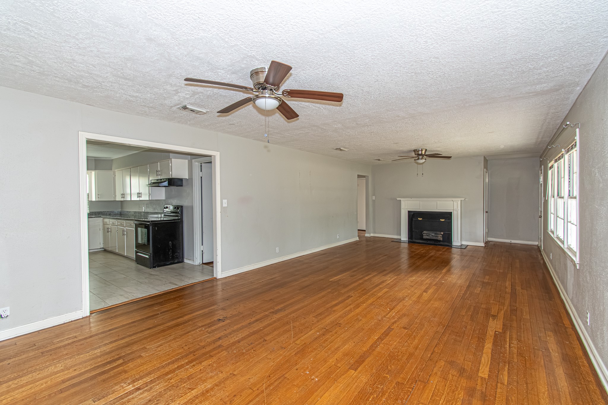 Look at this spacious living room with an inviting fireplace perfect for the Winter, and hardwood floors!