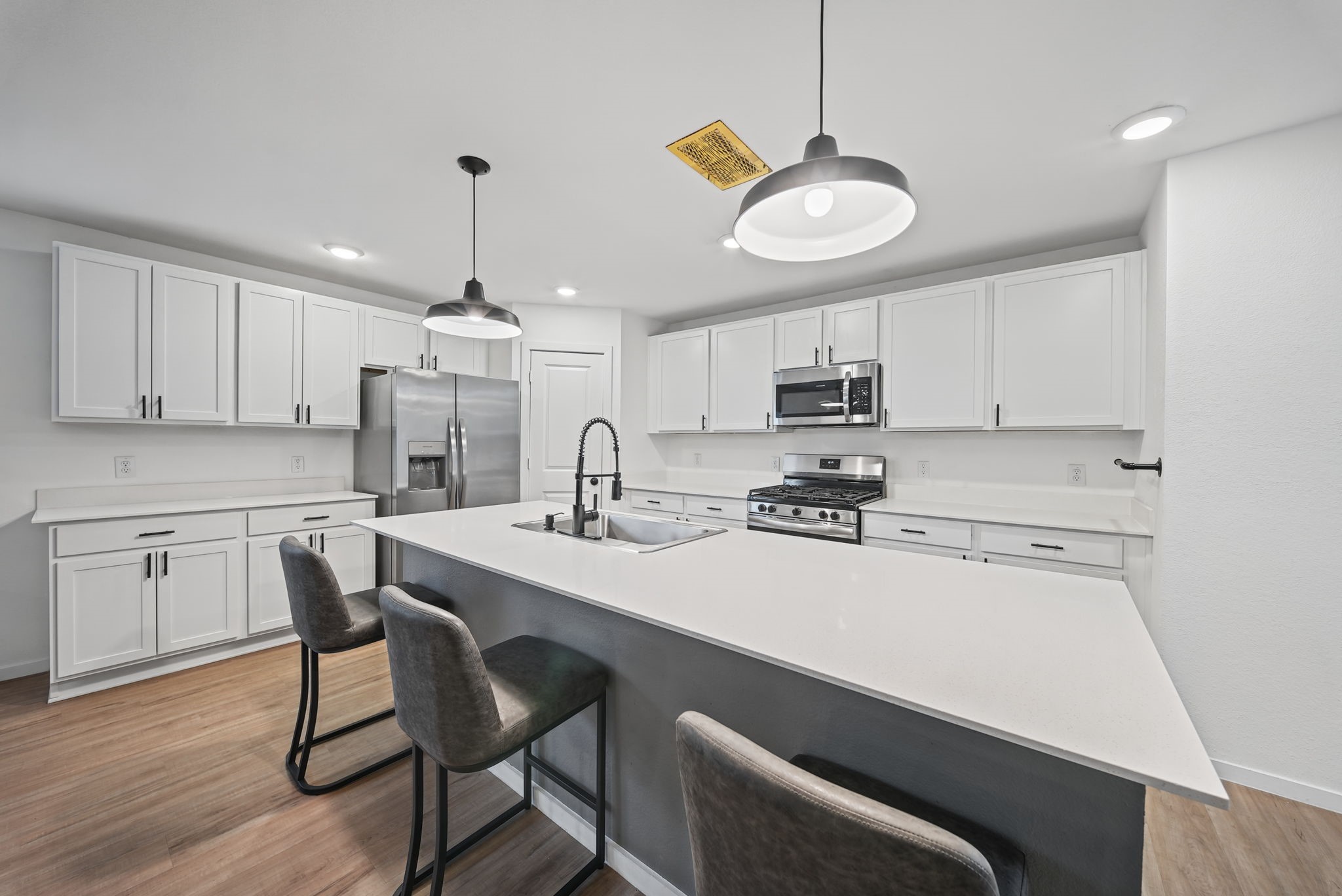 Love this island kitchen! Beautiful upgraded pendant lighting! Space for everyone here! Love this island kitchen! Beautiful upgraded pendant lighting! Space for everyone here!