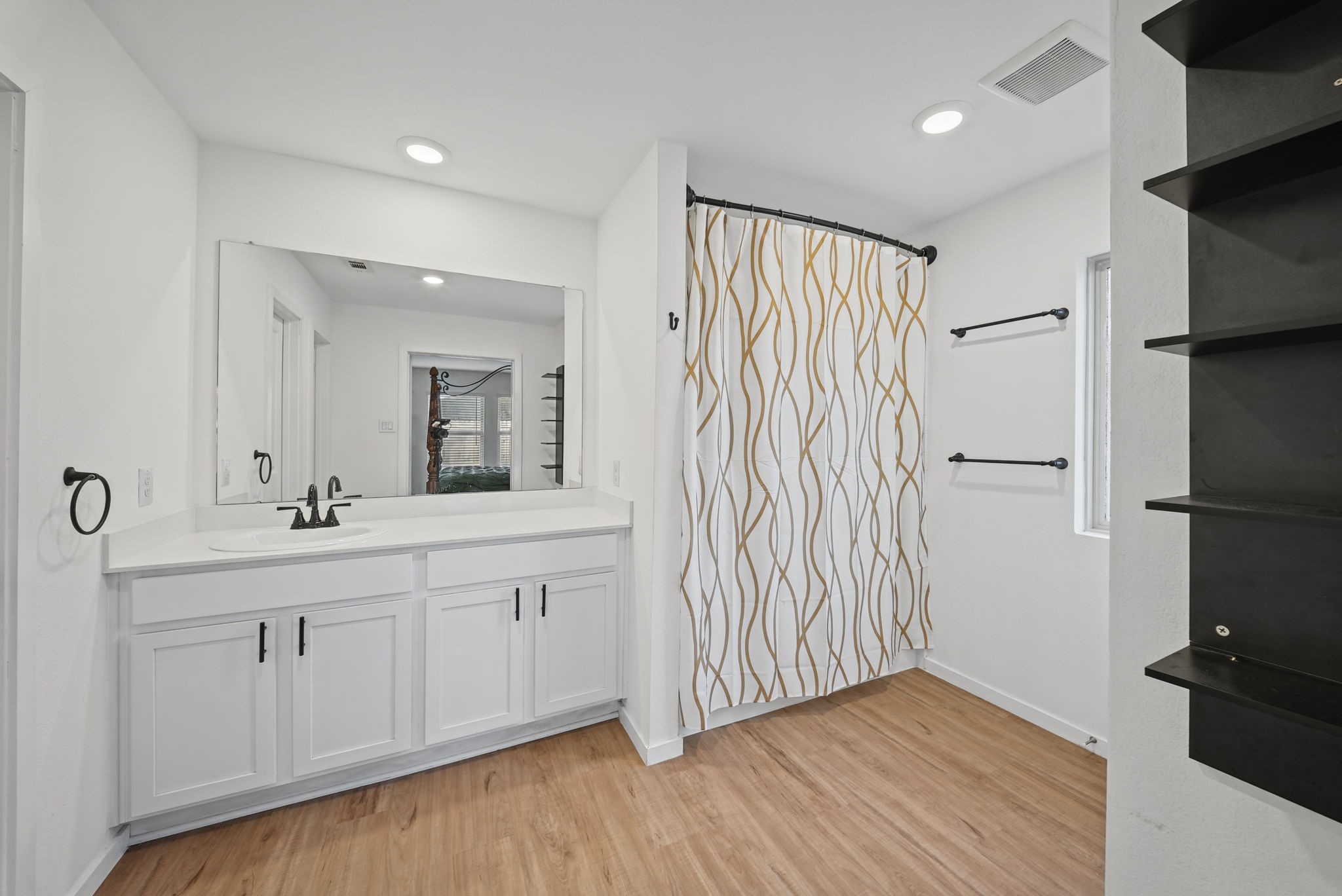 Primary Bath-- Replaced the primary bathroom sink faucet with an updated fixture.

- Installed matte-black cabinet handles to complement the bathroom's updated appearance.