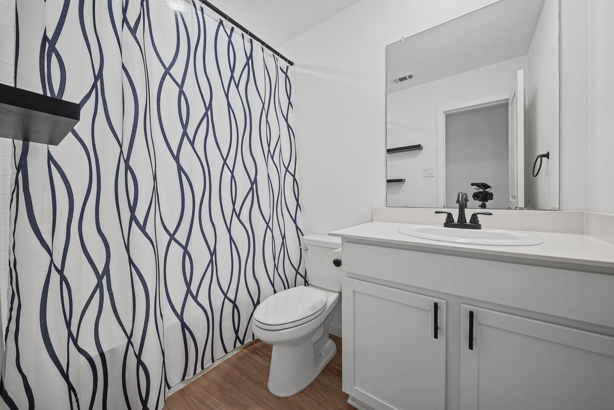 Secondary Bath-- Upgraded the front bathroom sink faucet to a modern matte-black finish.

- Installed coordinating matte-black cabinet handles in the front bathroom.