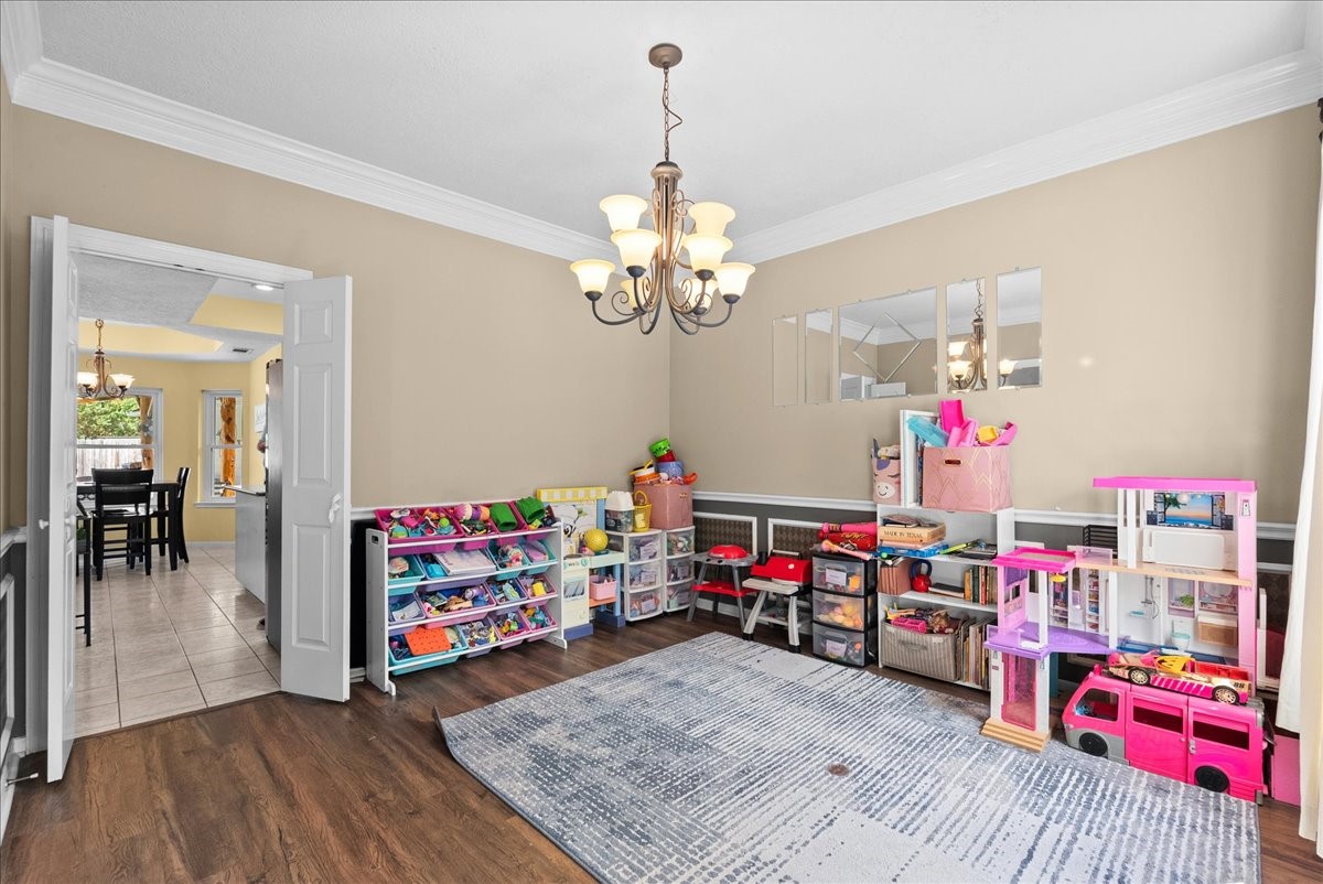 Walk your way from the kitchen to the formal dining room currently used as a kids playroom.