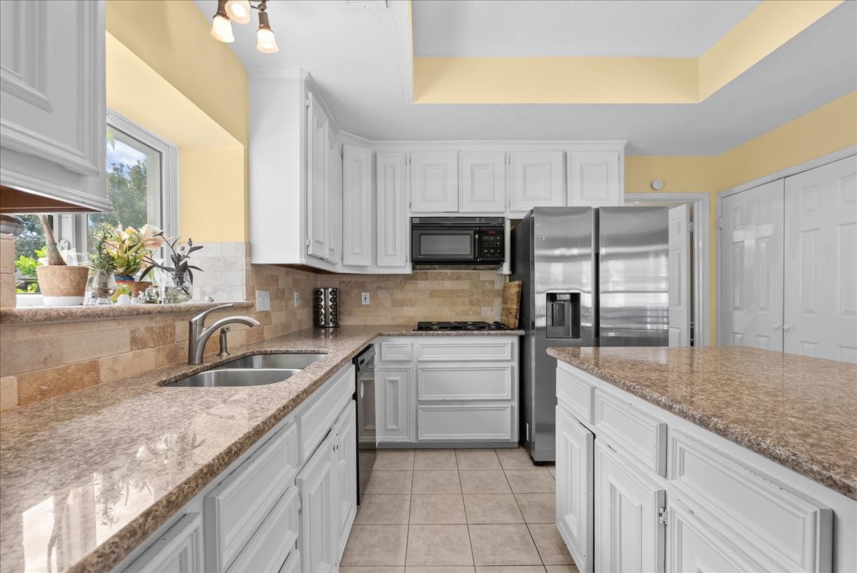 White cabinets, granite counter-tops makes this home even more inviting.