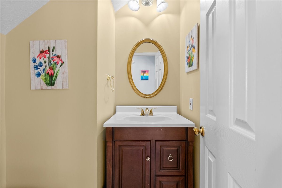 Half bathroom downstairs with an updated vanity.