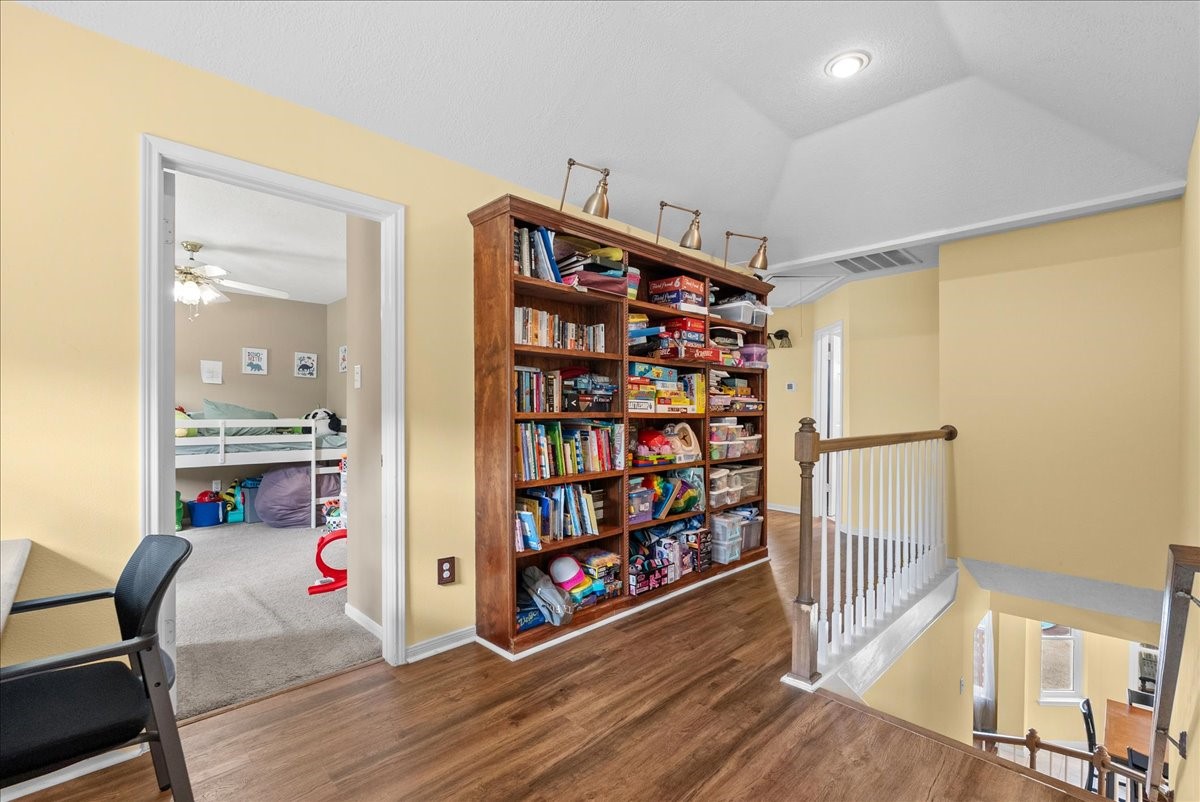 The landing offers a fantastic option for a secondary office or homework area with all wood built-ins.