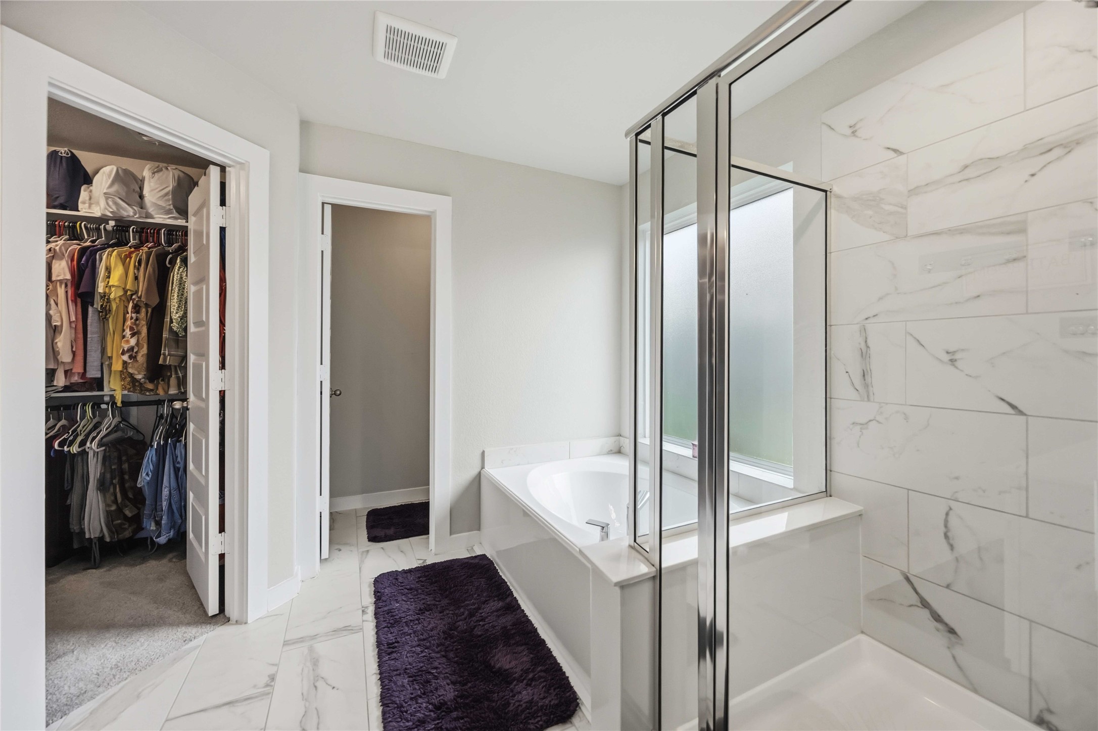 Step into the spacious primary bathroom, complete with a walk-in closet for added comfort and convenience.