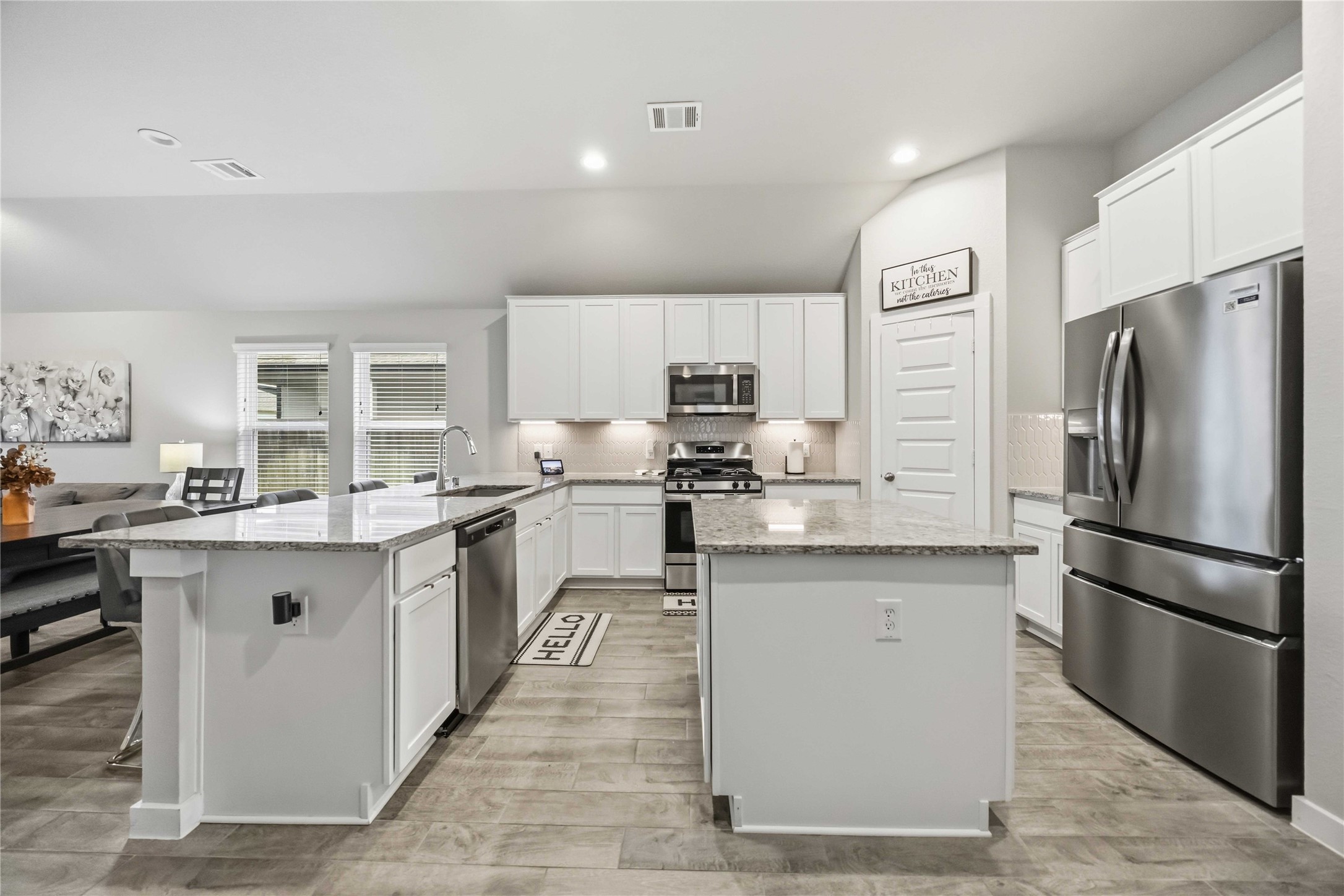 The choice of color for the cabinets, countertops and flooring open up the space and make decorating a breeze.