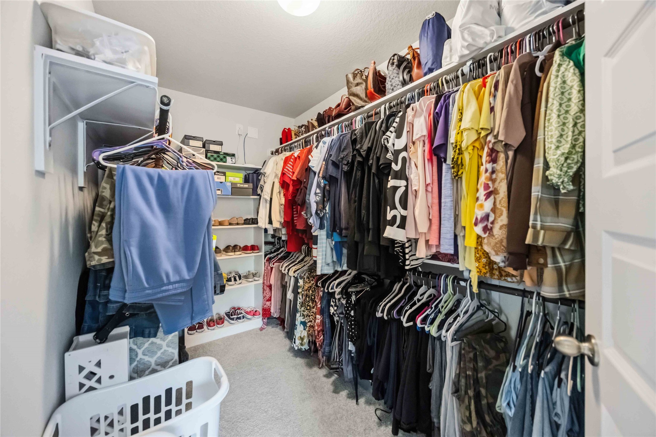 Plenty of room to organize and store with this spacious primary walk-in closet!