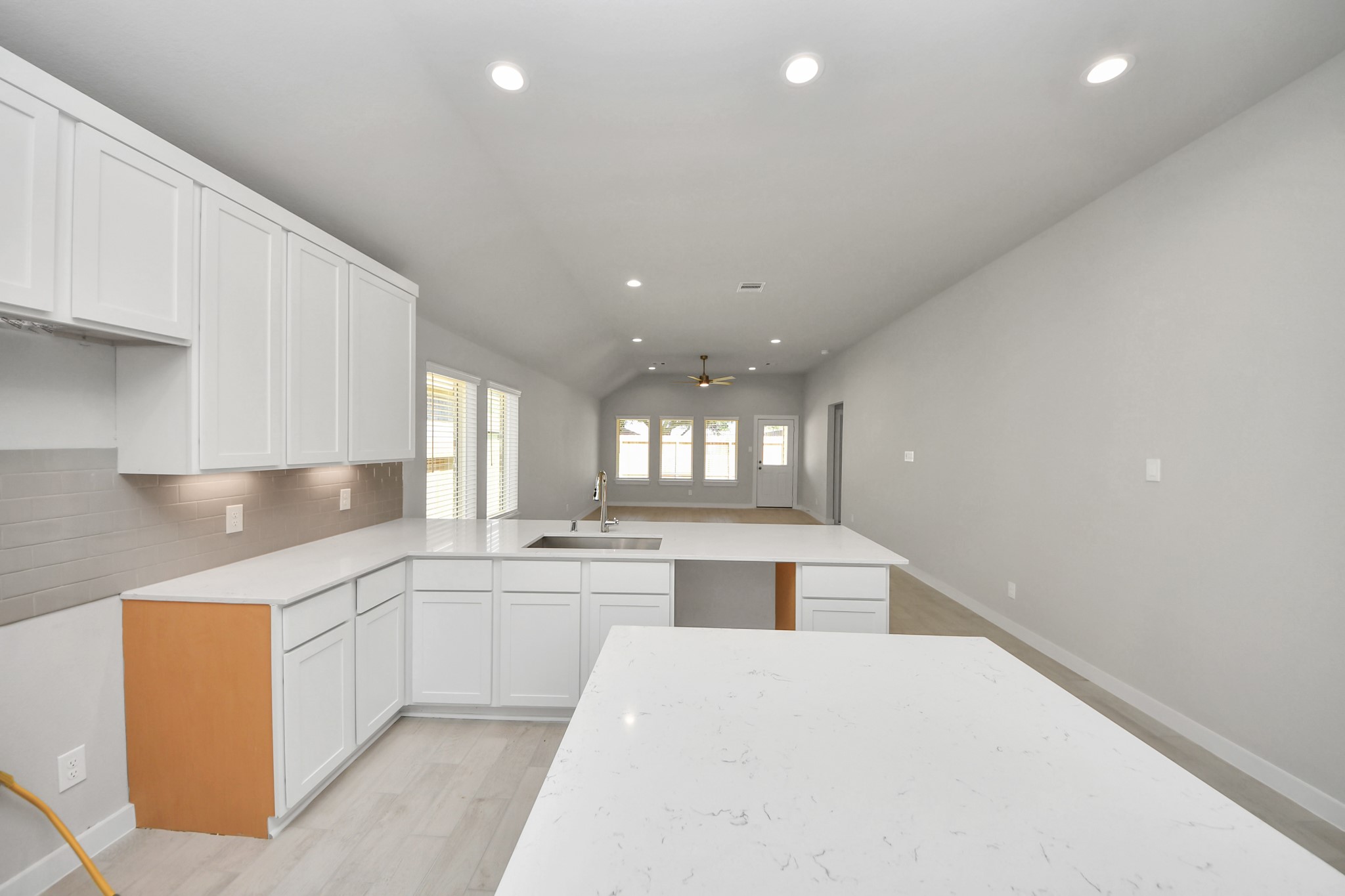 The open concept effortlessly connects the kitchen to the expansive family room, forming a perfect hub for gatherings. This seamless flow creates an inviting space where cooking and socializing come together harmoniously. Sample photo of completed home with similar floor plan. Actual colors and selections may vary.