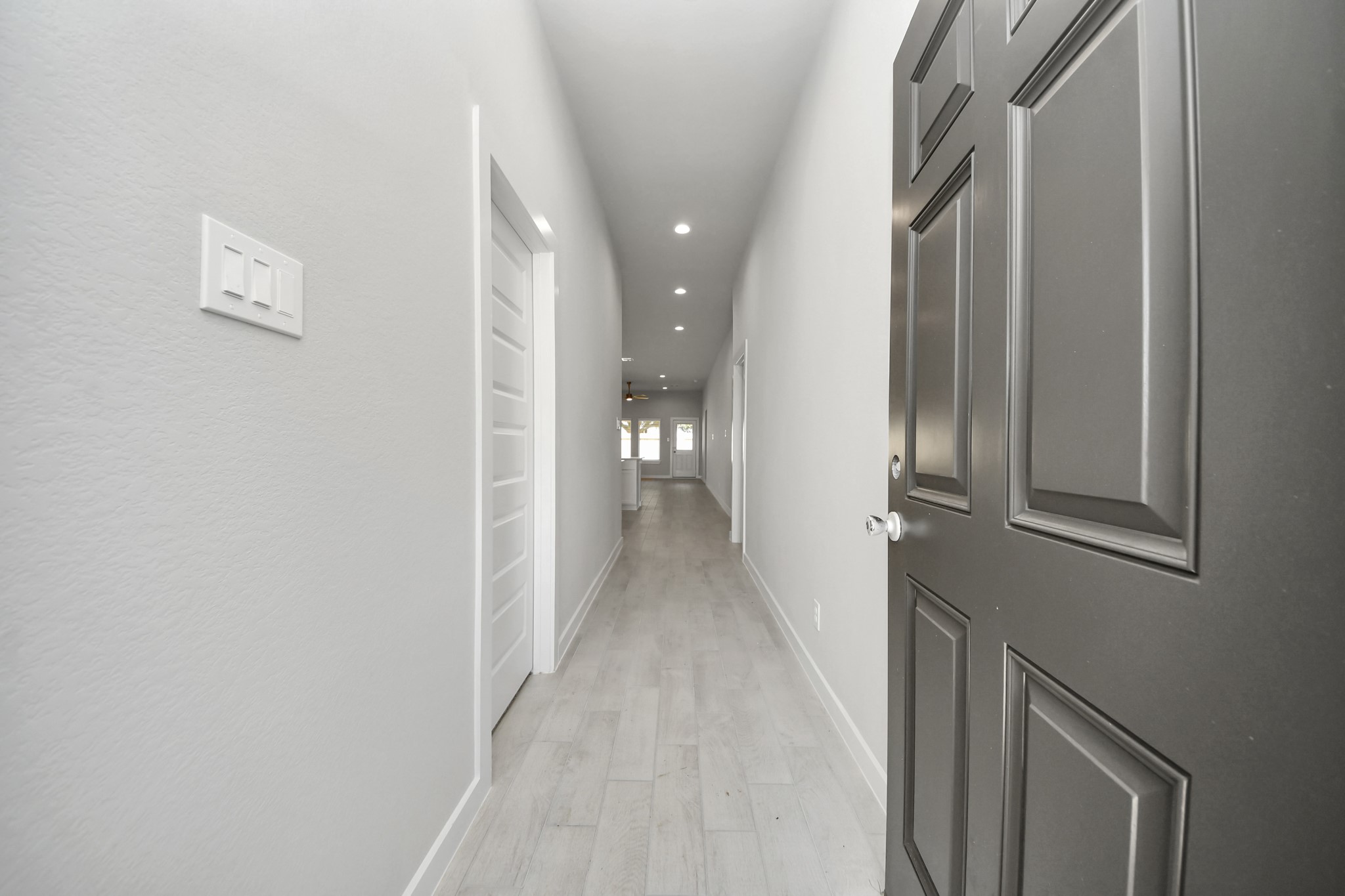 As you step into the threshold of this luxurious home, you'll soon be welcomed by an elegant glass door (to be installed). Inside, soaring ceilings amplify the spaciousness, while the refined wood-look tile flooring and oversized baseboards exude sophistication and charm. Sample photo of completed home with similar floor plan. Actual colors and selections may vary.
