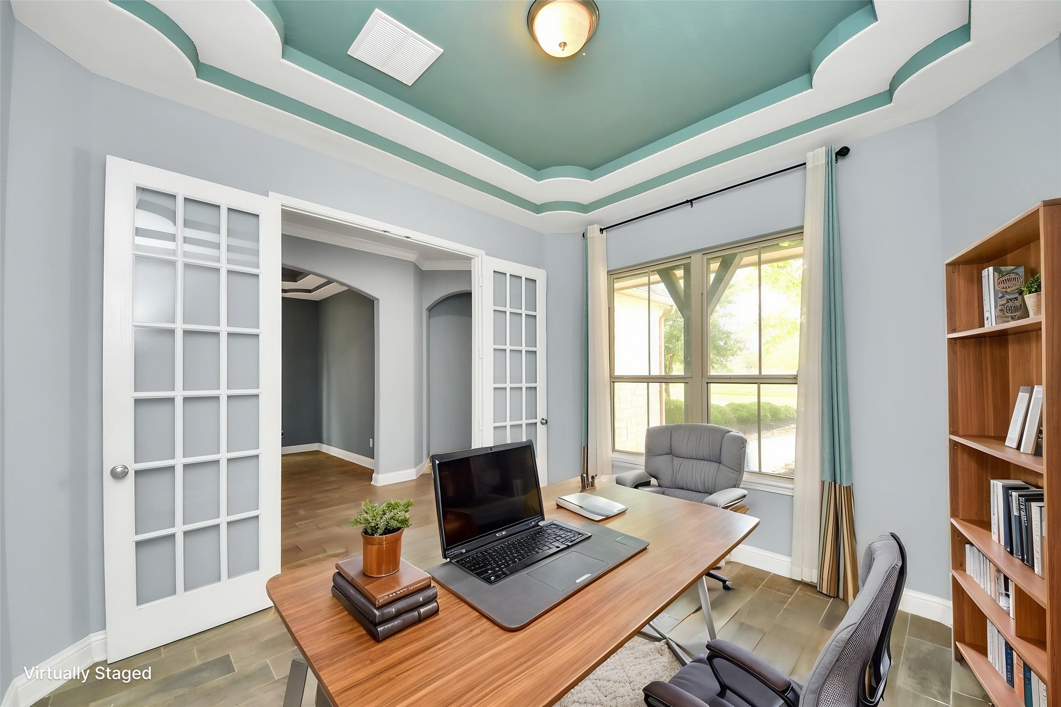 Virtually Staged Dedicated home office with French doors, decorative ceiling detail, large window, and virtual staging. Virtually Staged Dedicated home office with French doors, decorative ceiling detail, large window, and virtual staging.