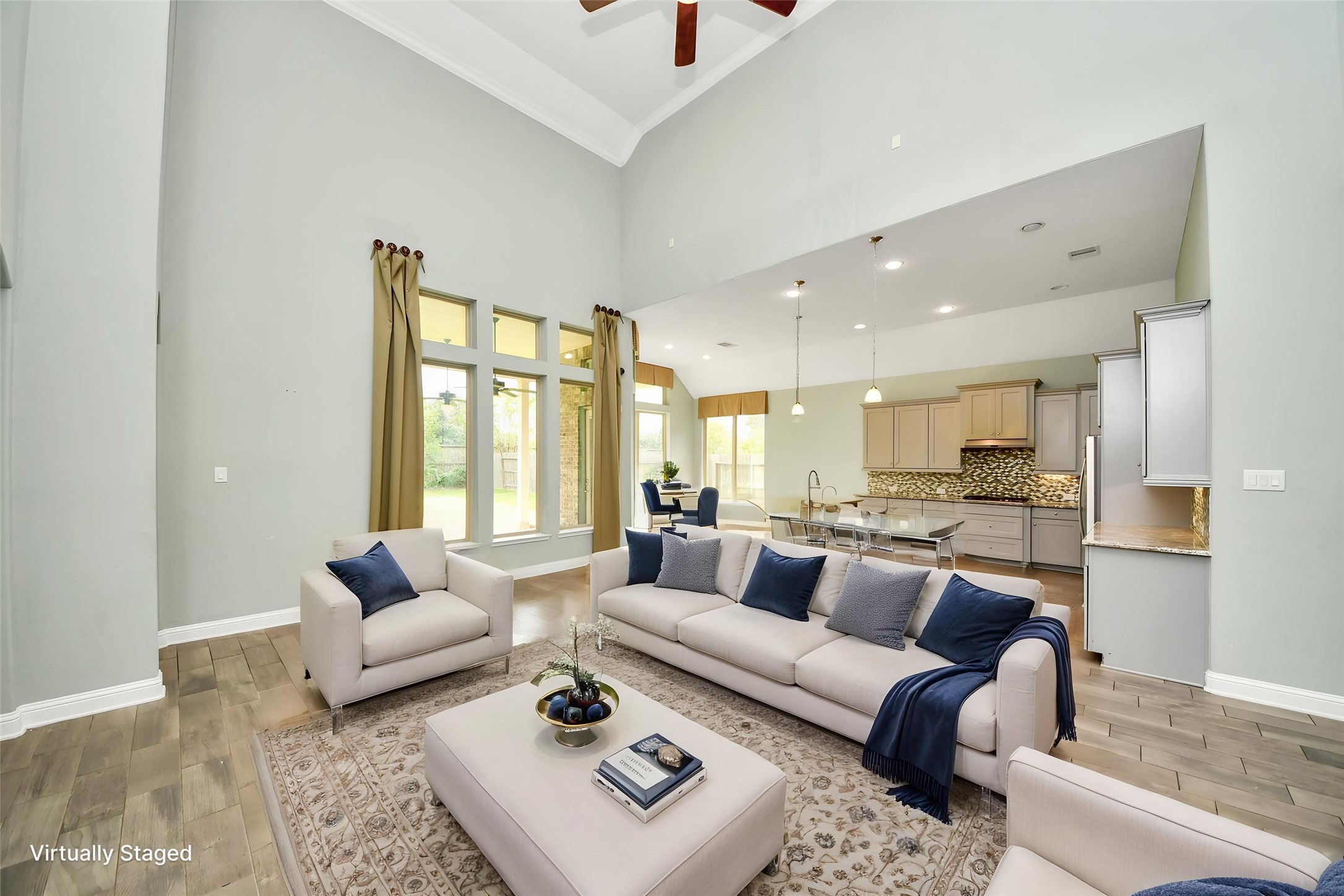 Virtually Staged Open-concept living area flows seamlessly into the kitchen, highlighted by soaring ceilings and abundant natural light. Virtually Staged Open-concept living area flows seamlessly into the kitchen, highlighted by soaring ceilings and abundant natural light.